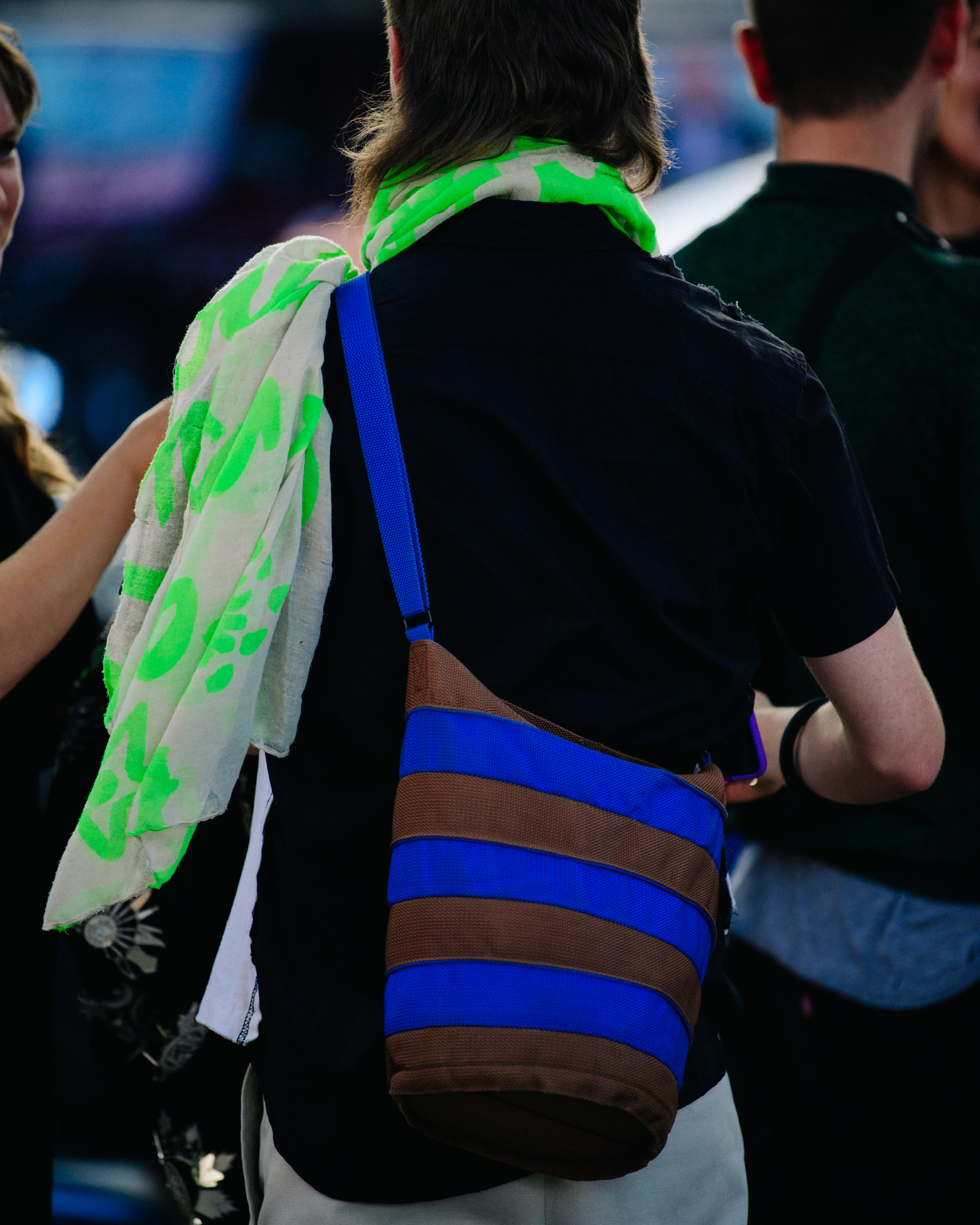 Man carrying blue striped bag