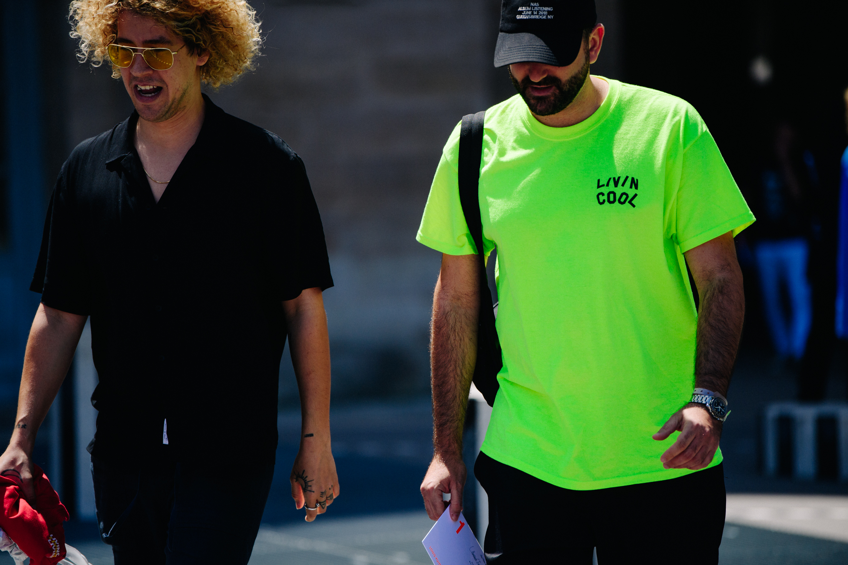 Two men wearing black and day glow