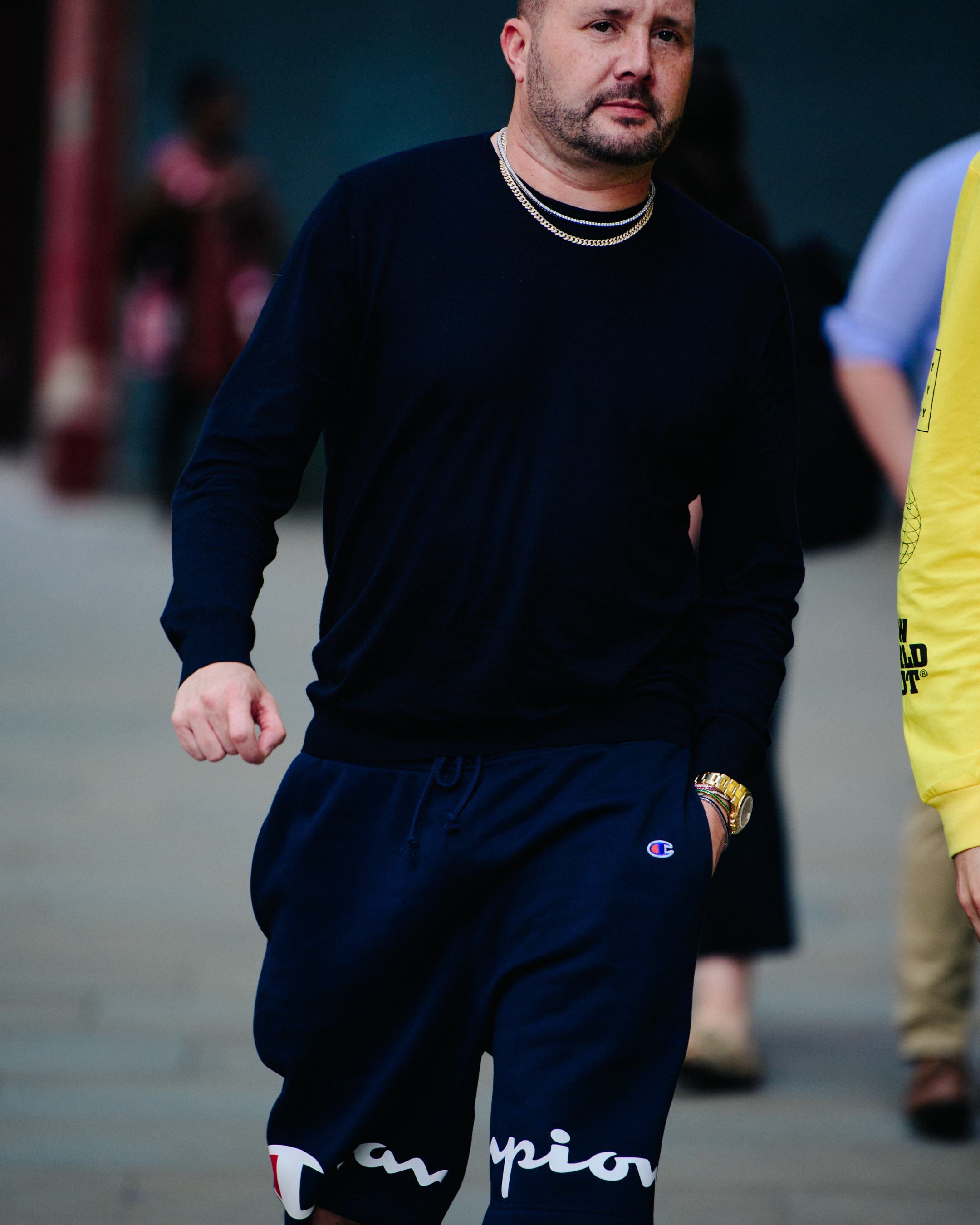 Man wearing silver and gold chains