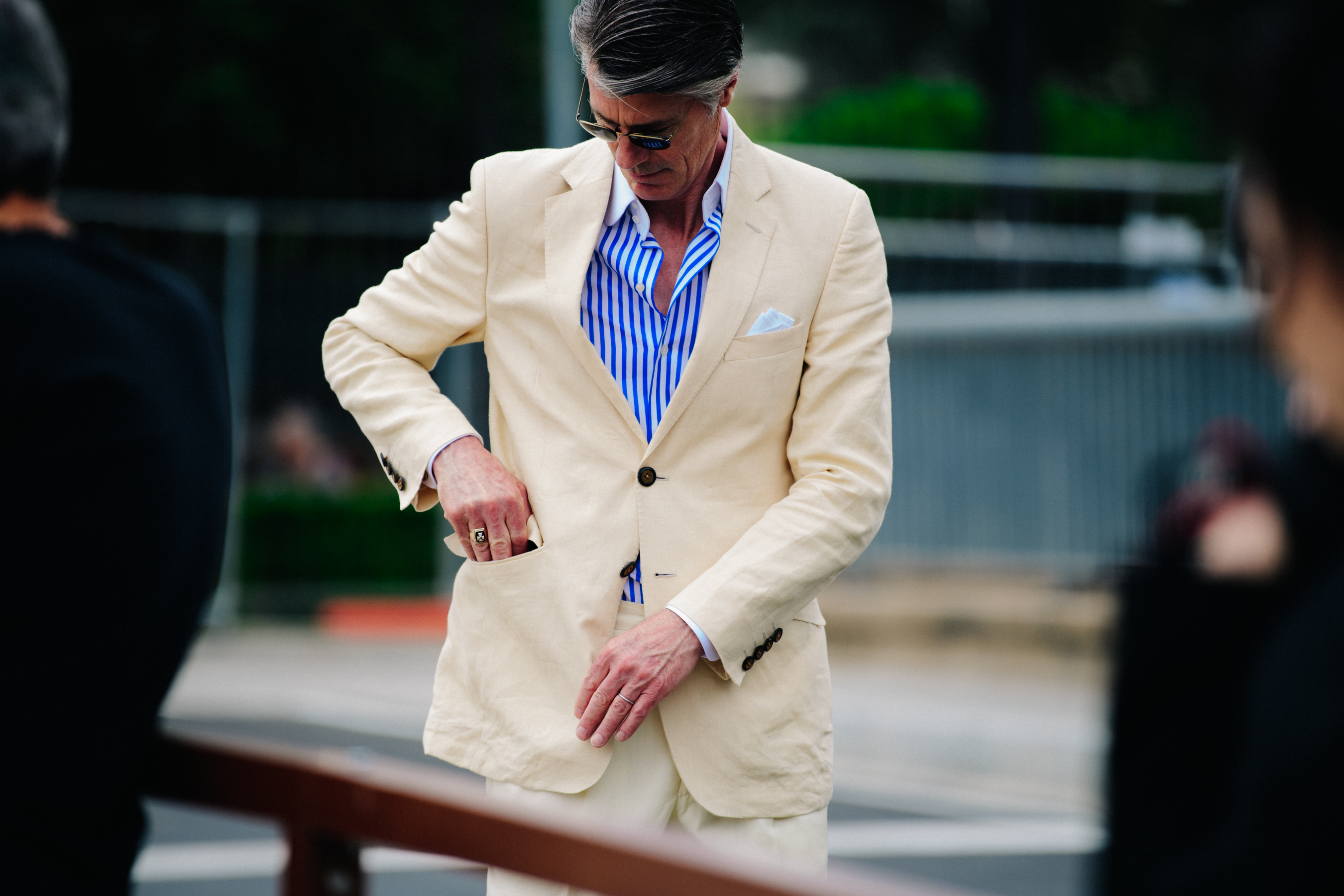 Man wearing pale suit