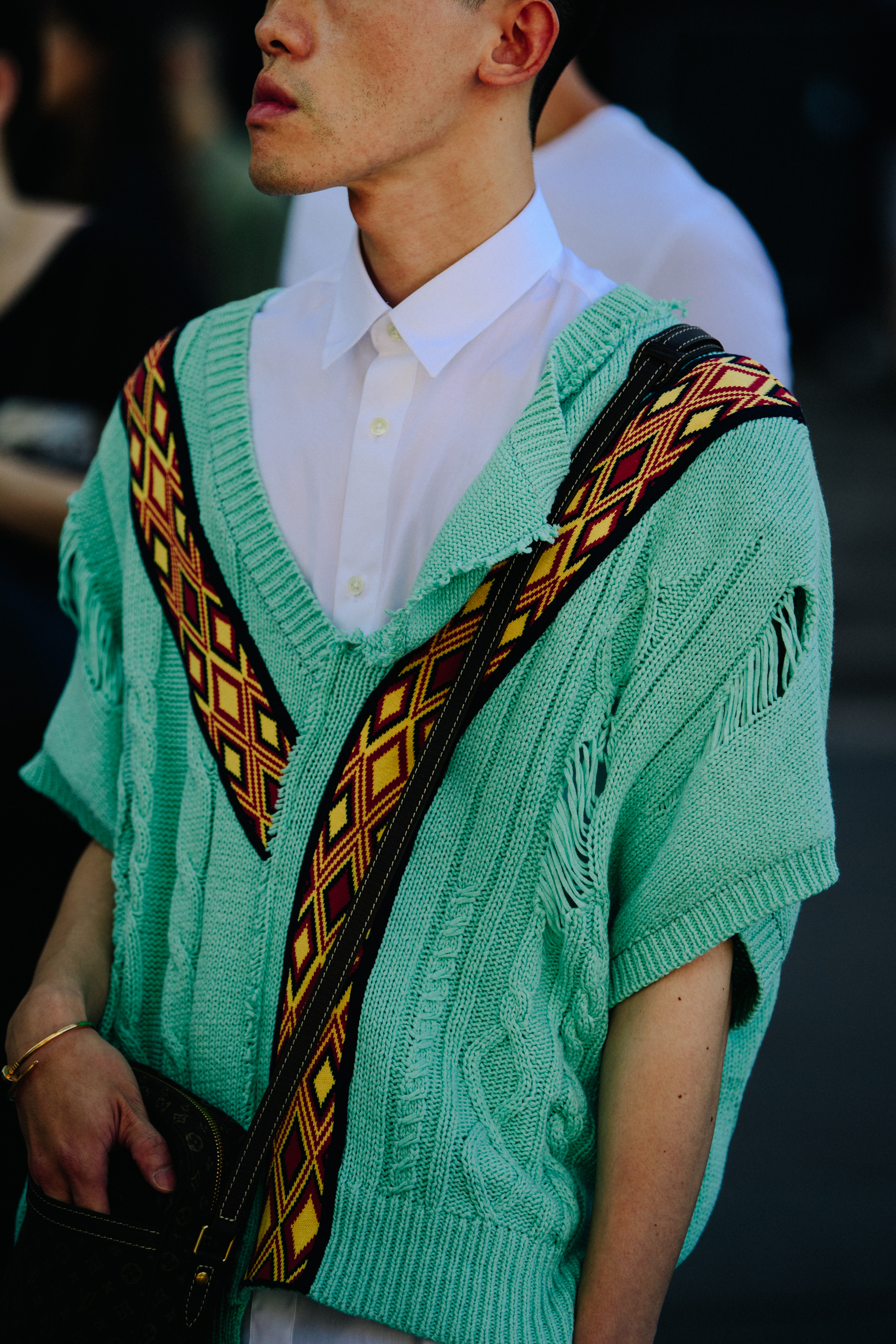 Man wearing green knit top