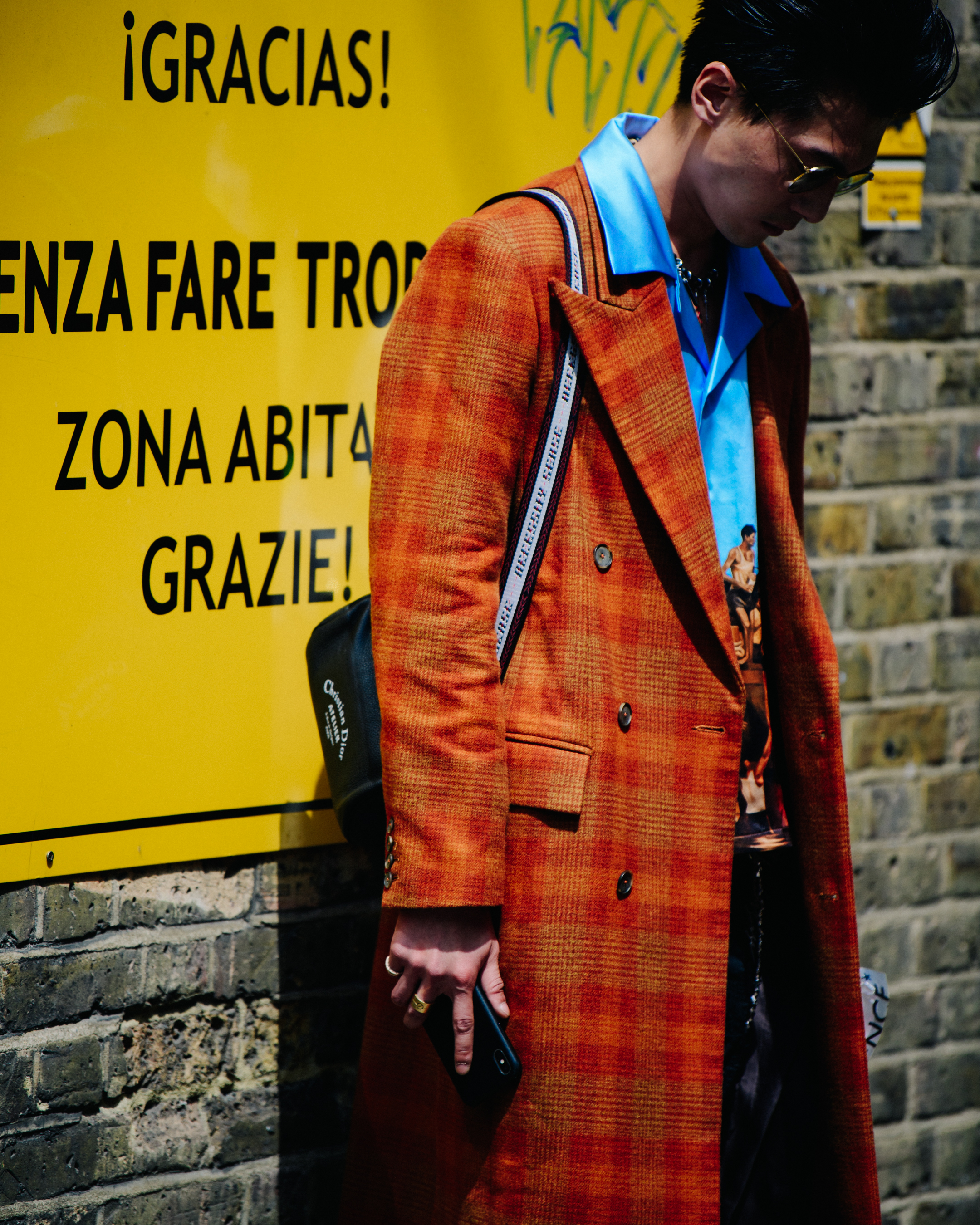 Man wearing long orange coat