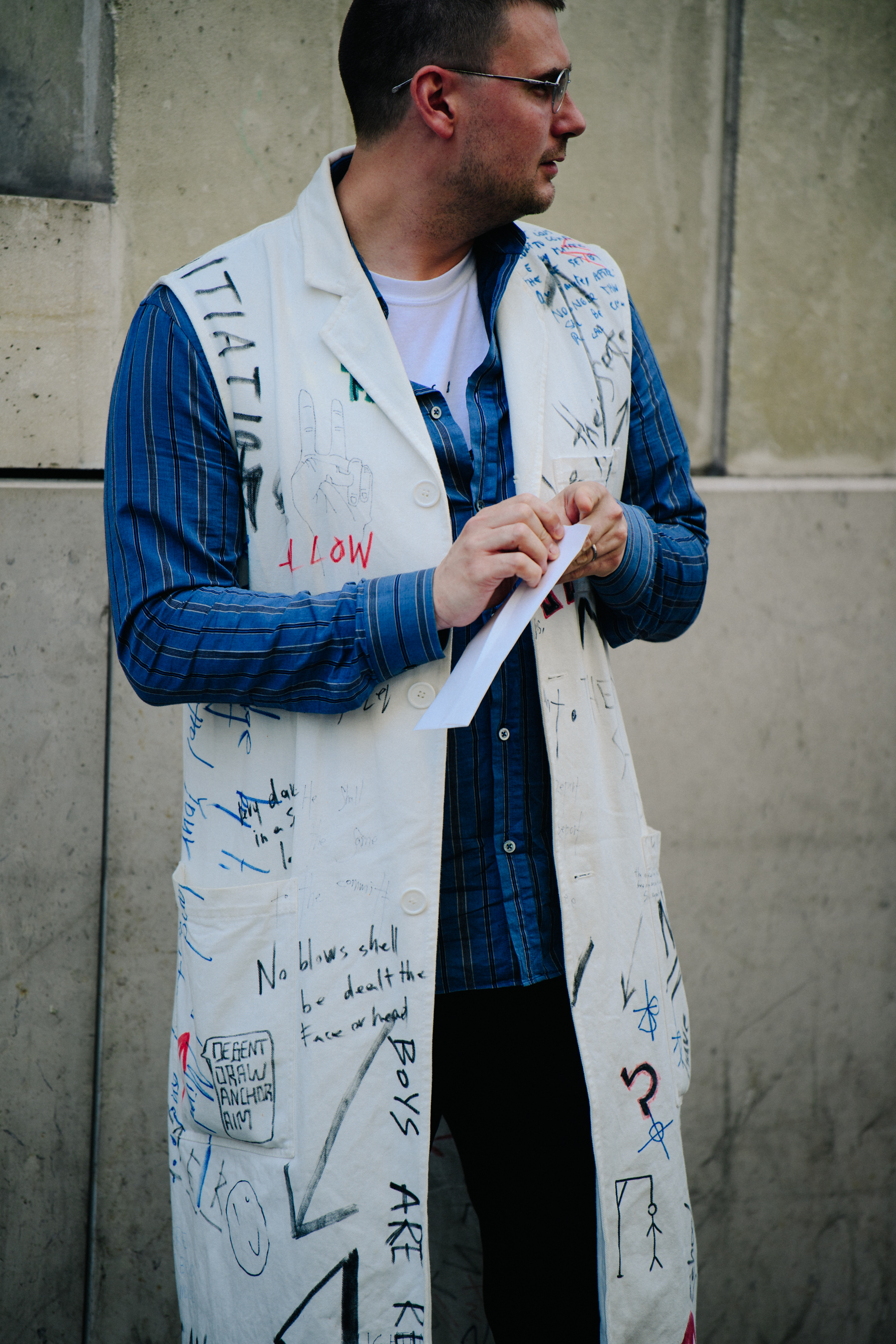 Man wearing hand written coat