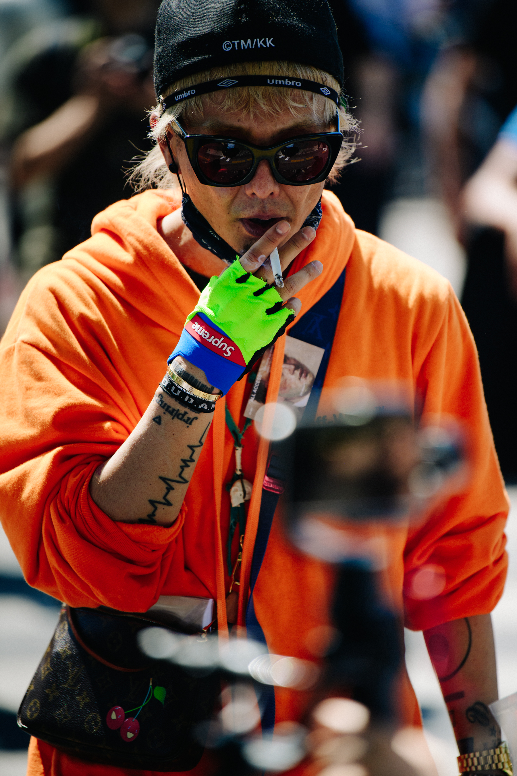 Asian man wearing orange hoodie
