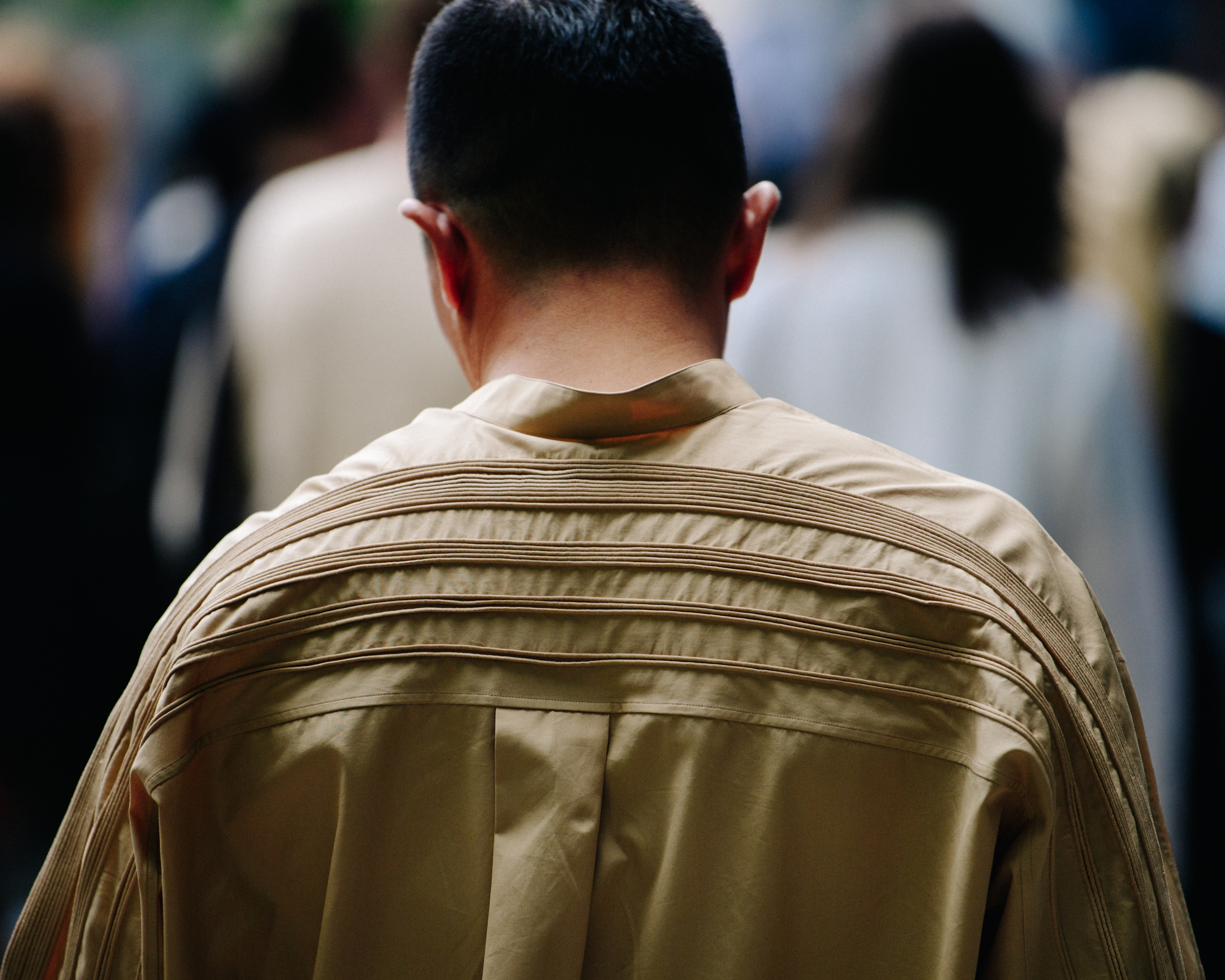 Man wearing tan shirt