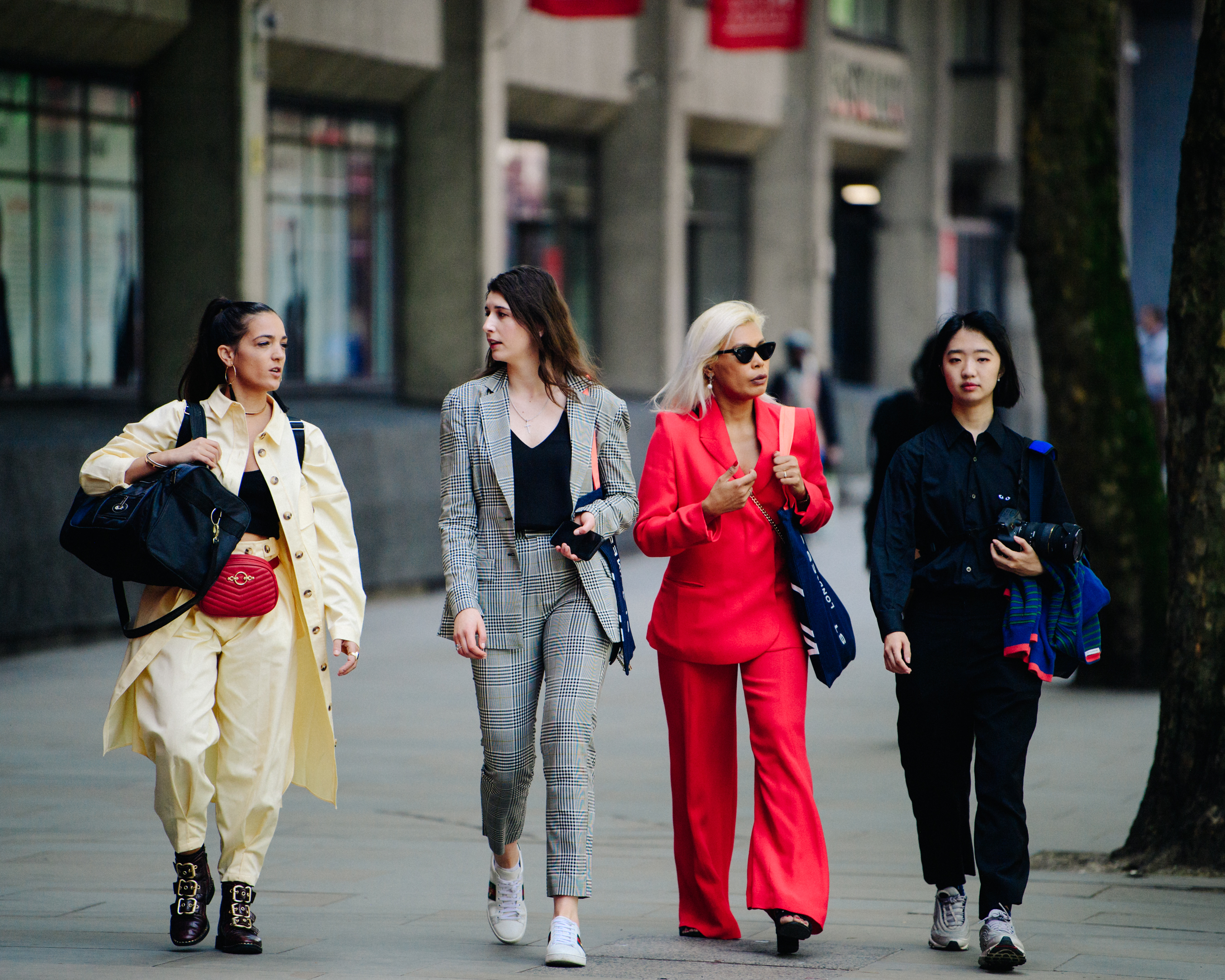 Group of women wearing colourful suits