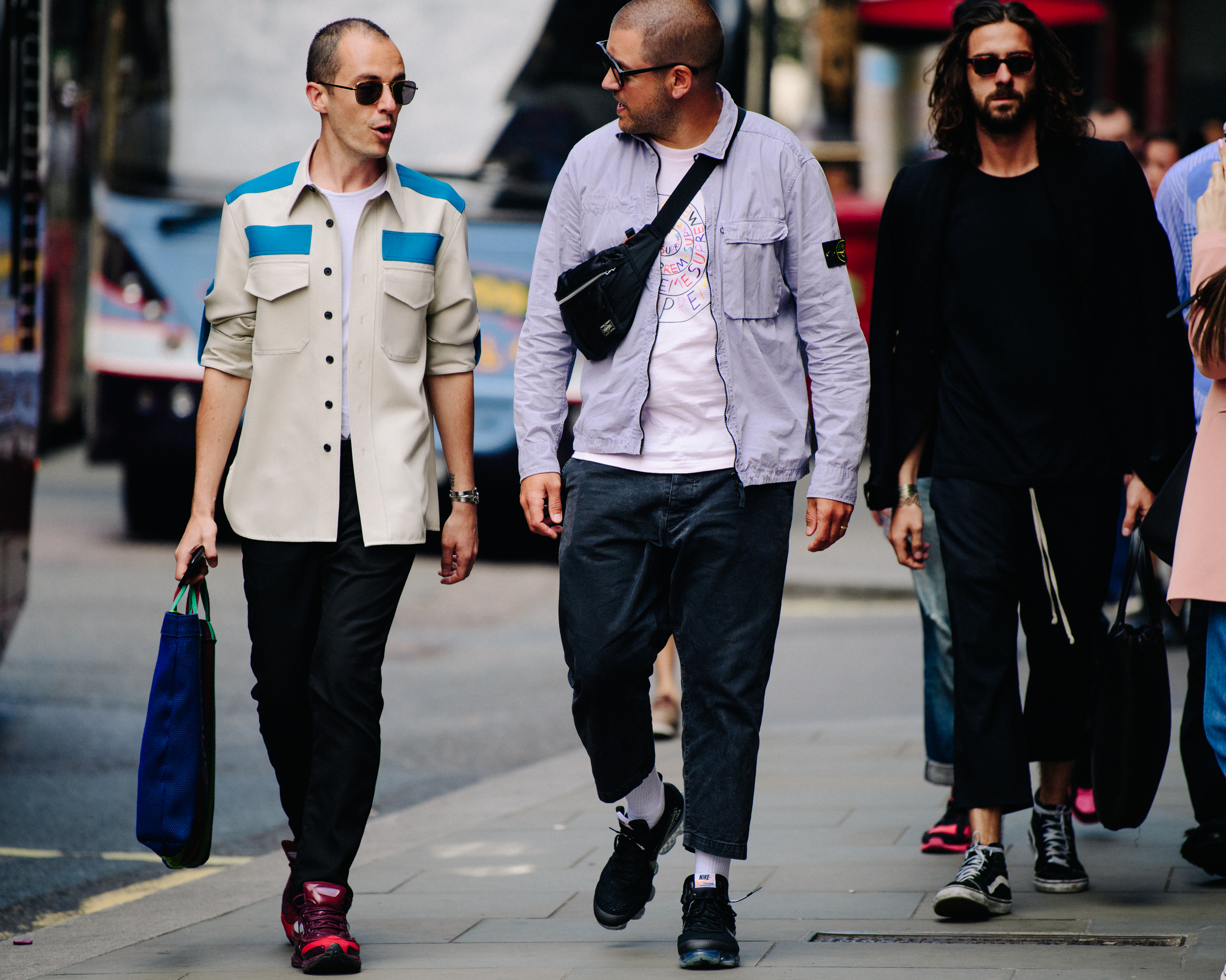 Three men wearing light outfits