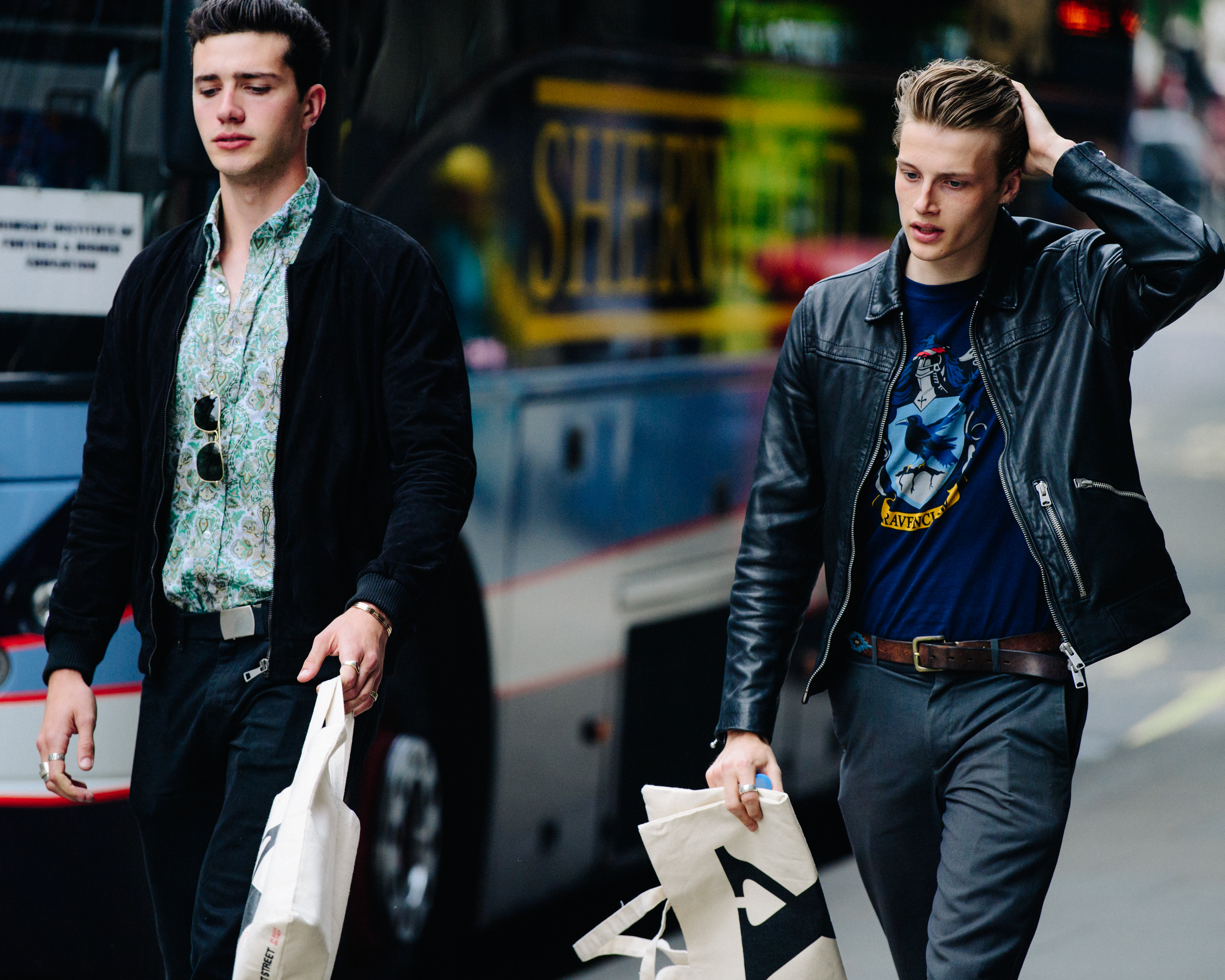 Two models wearing black jackets