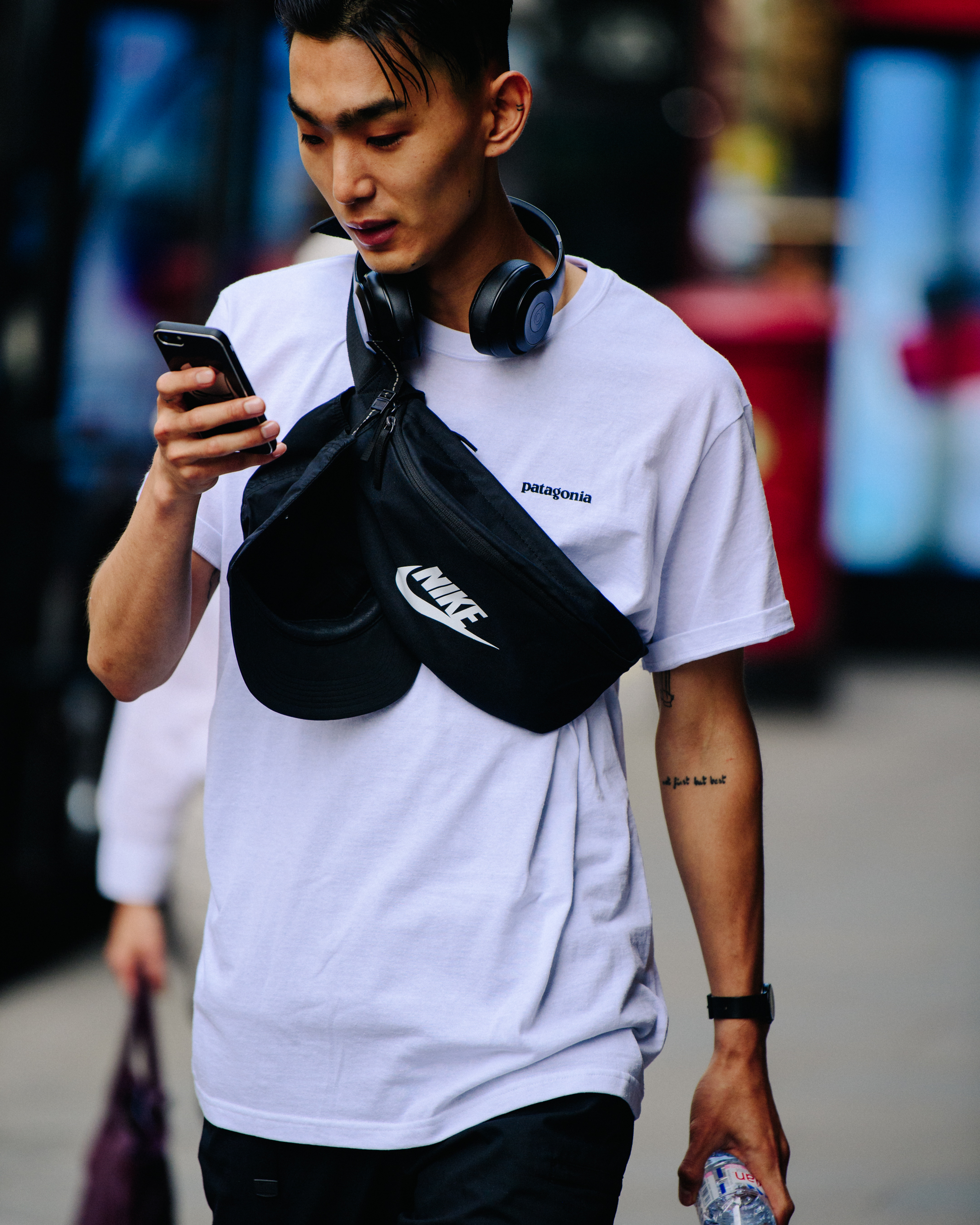 Asian man wearing black hip bag