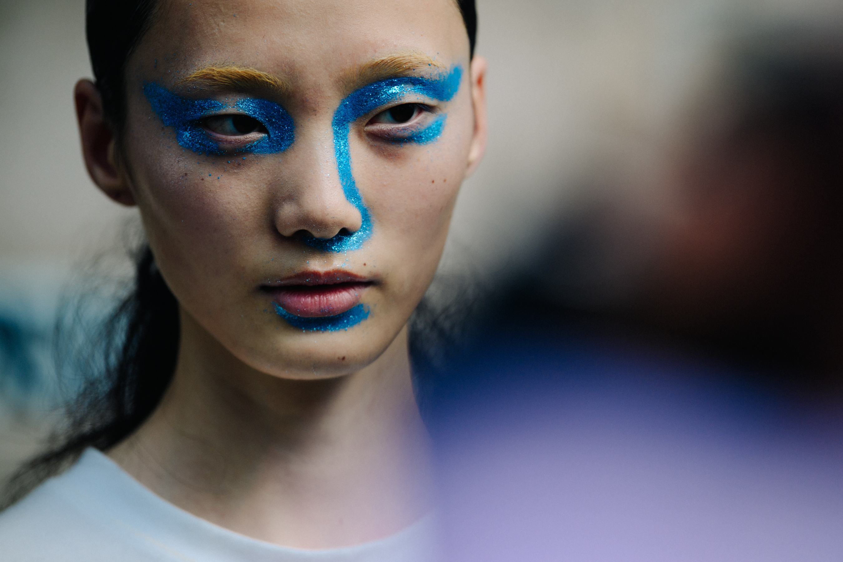 Model wearing blue facepaint