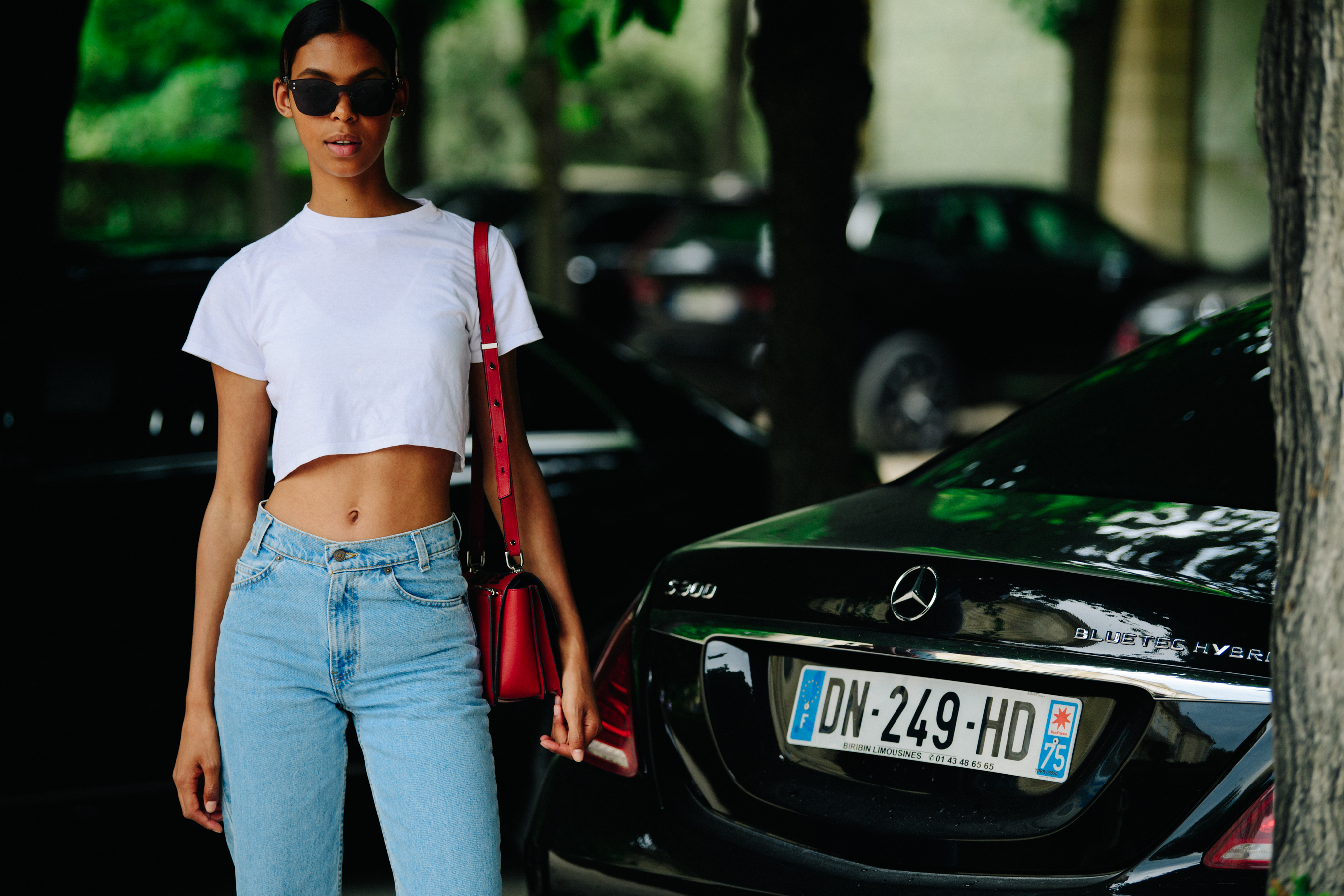 Model wearing white crop tee shirt