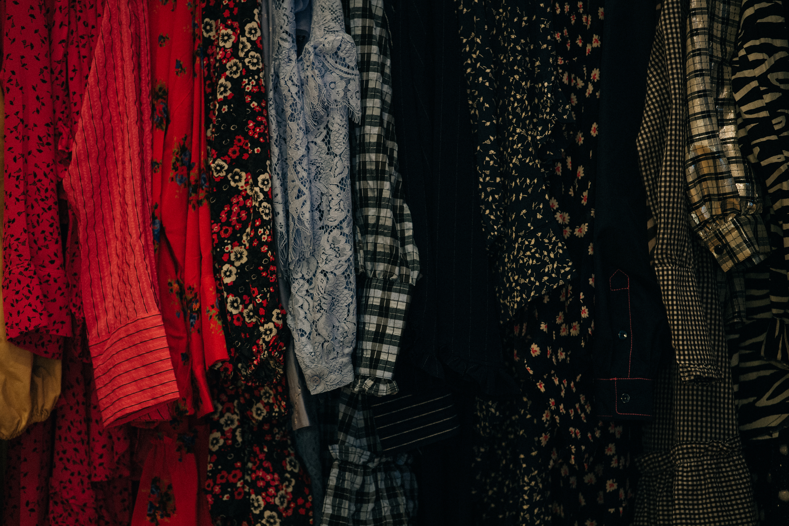Clothes hanging backstage at Ganni
