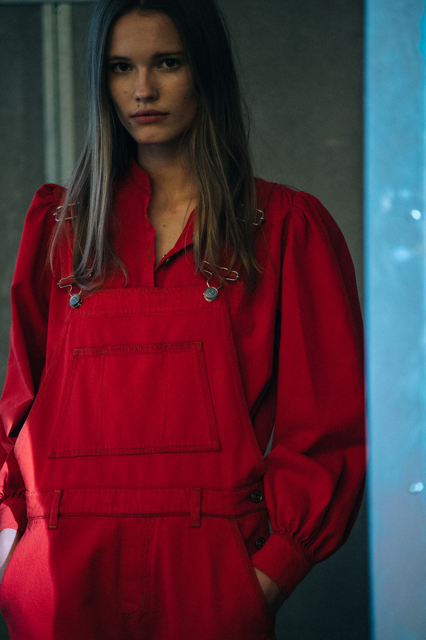 Model wearing red dungarees at Ganni