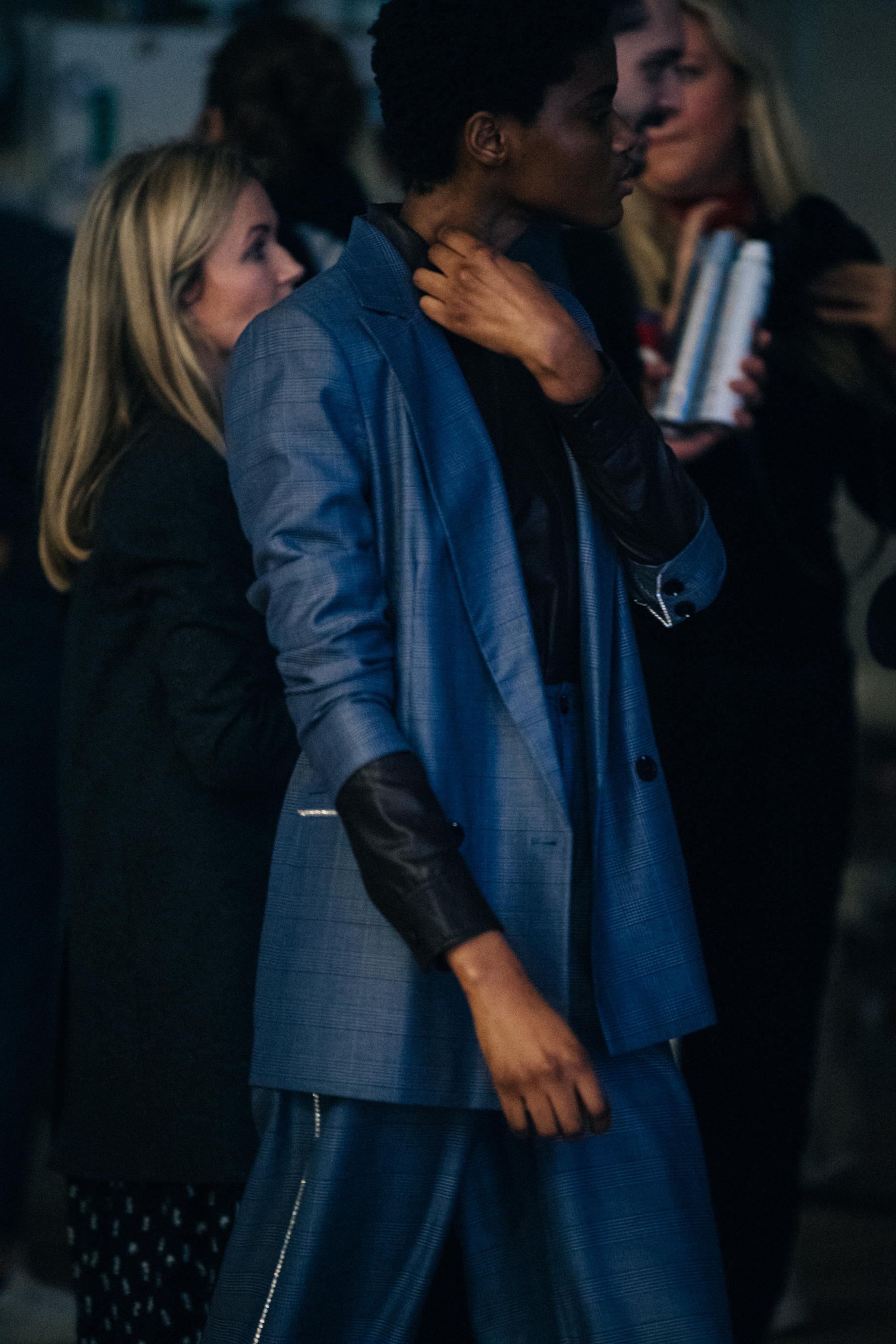 Model wearing blue outfit backstage