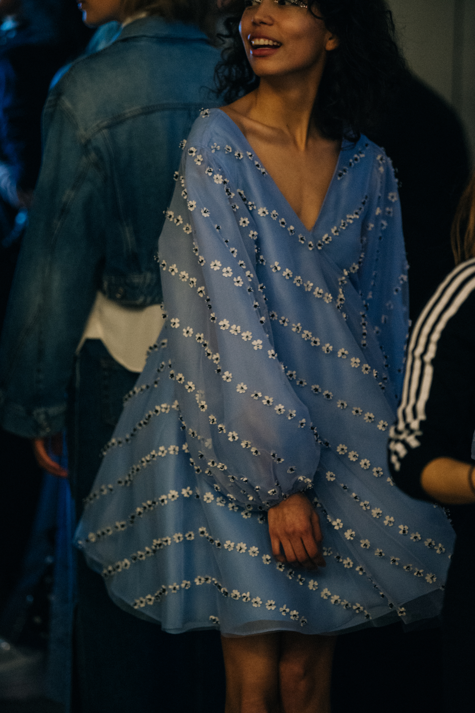 Model wearing blue outfit backstage