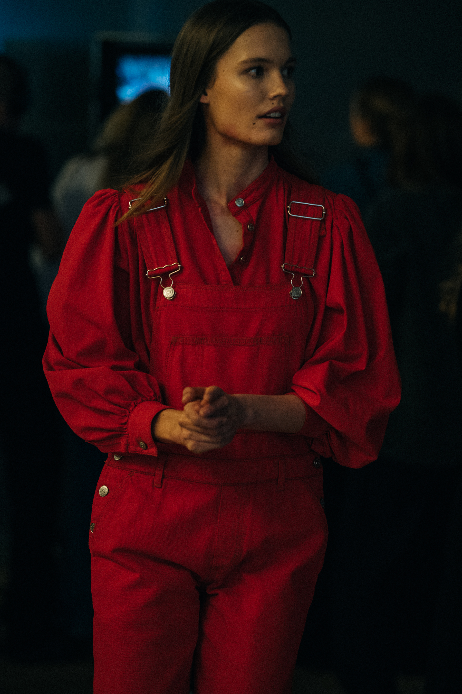 Model wearing red dungarees at Ganni