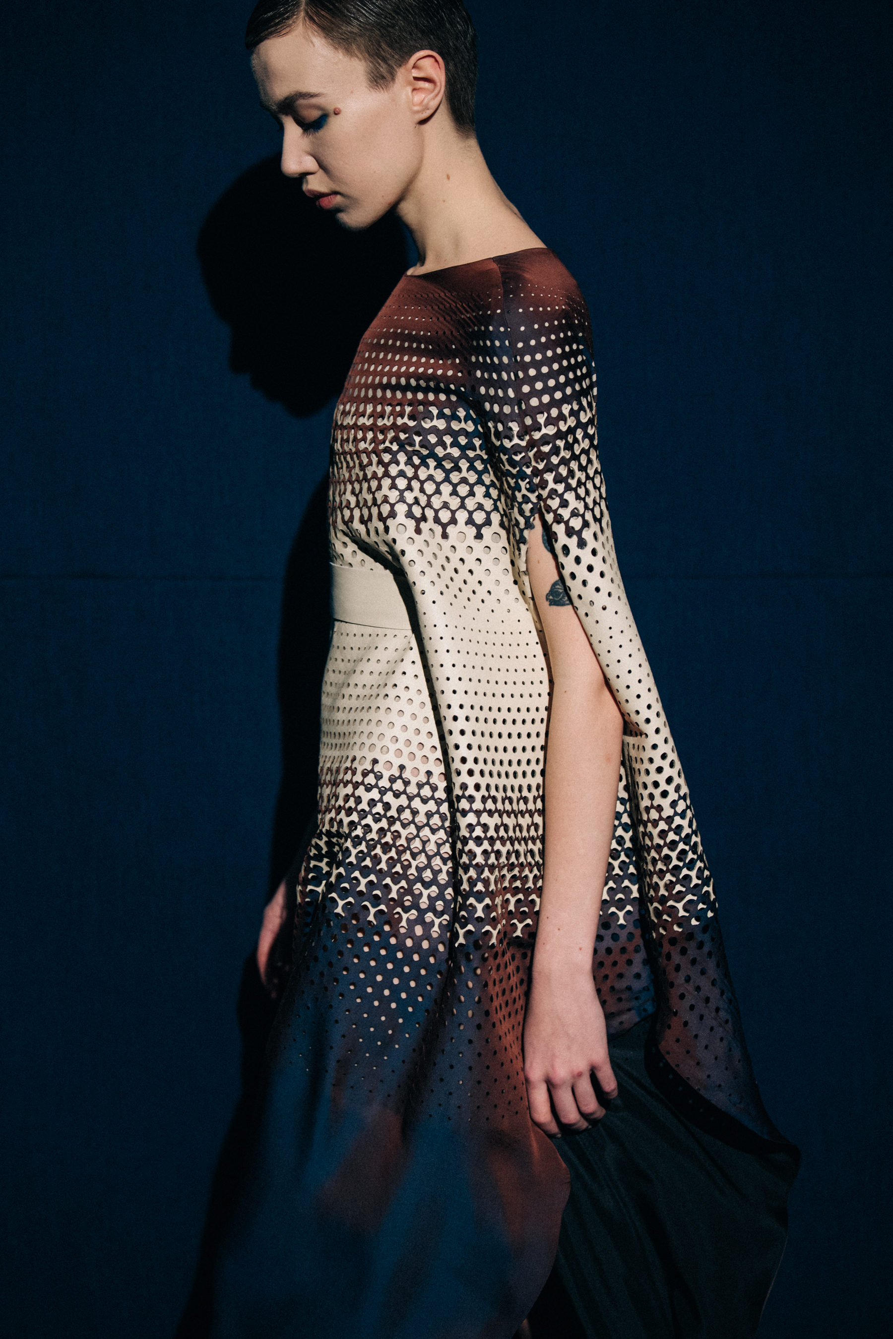Model wearing black and cream dress