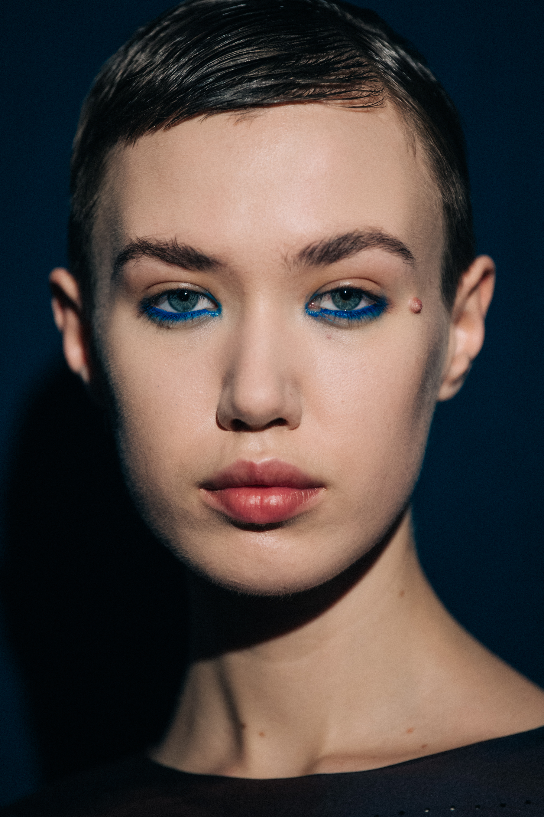 Portrait of model wearing blue eye makeup