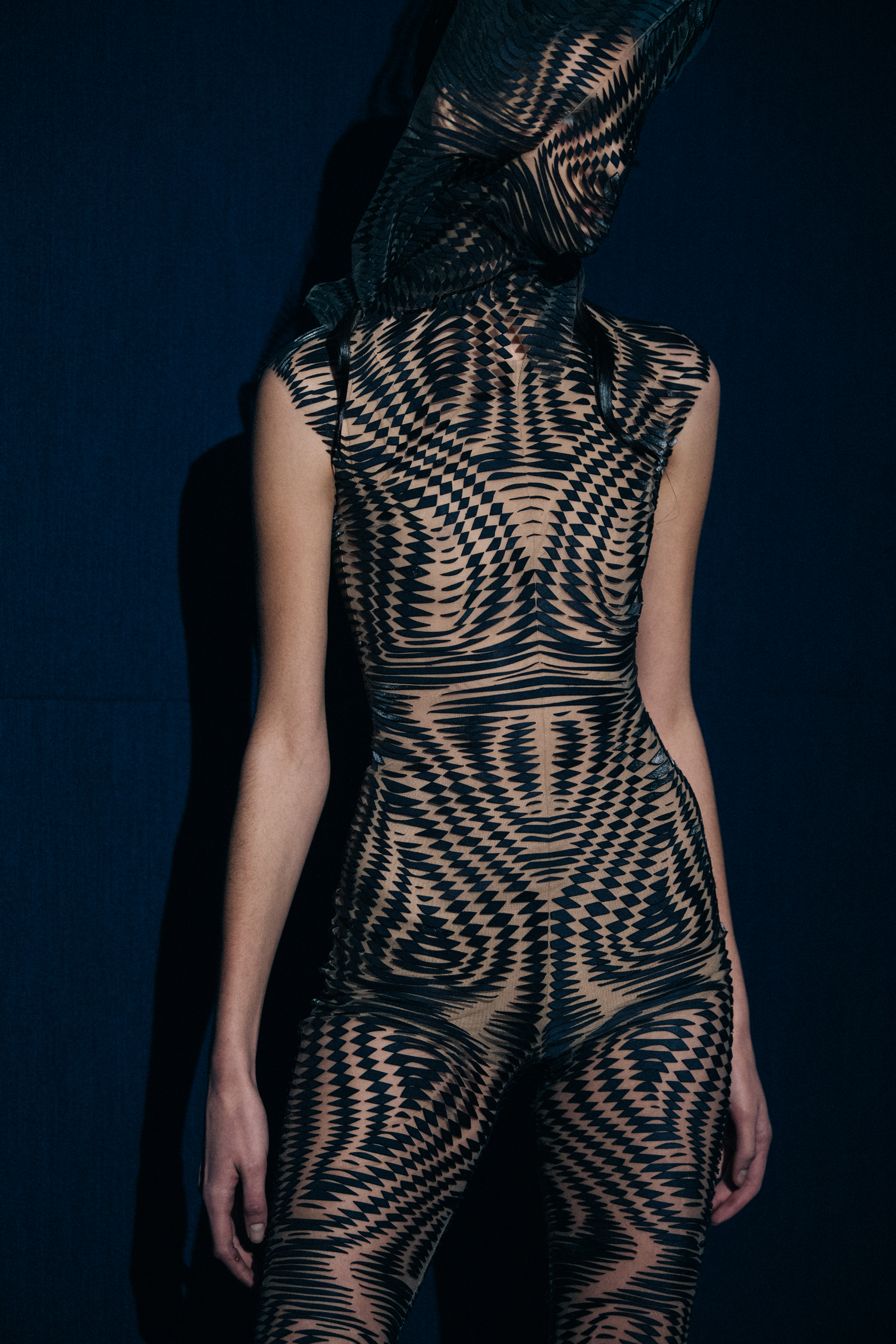 Model wearing black face mask and dress