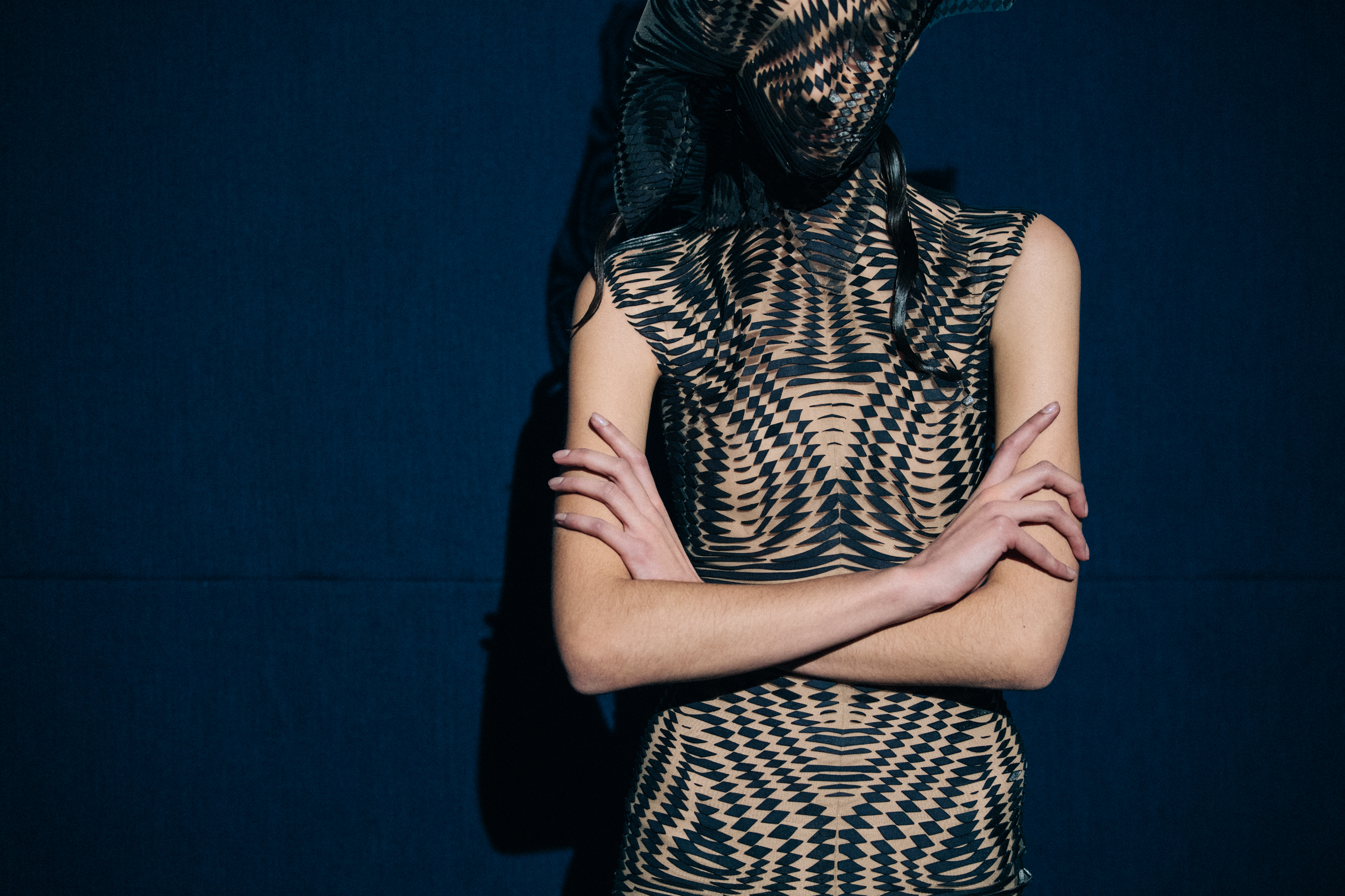 Model wearing black face mask and dress