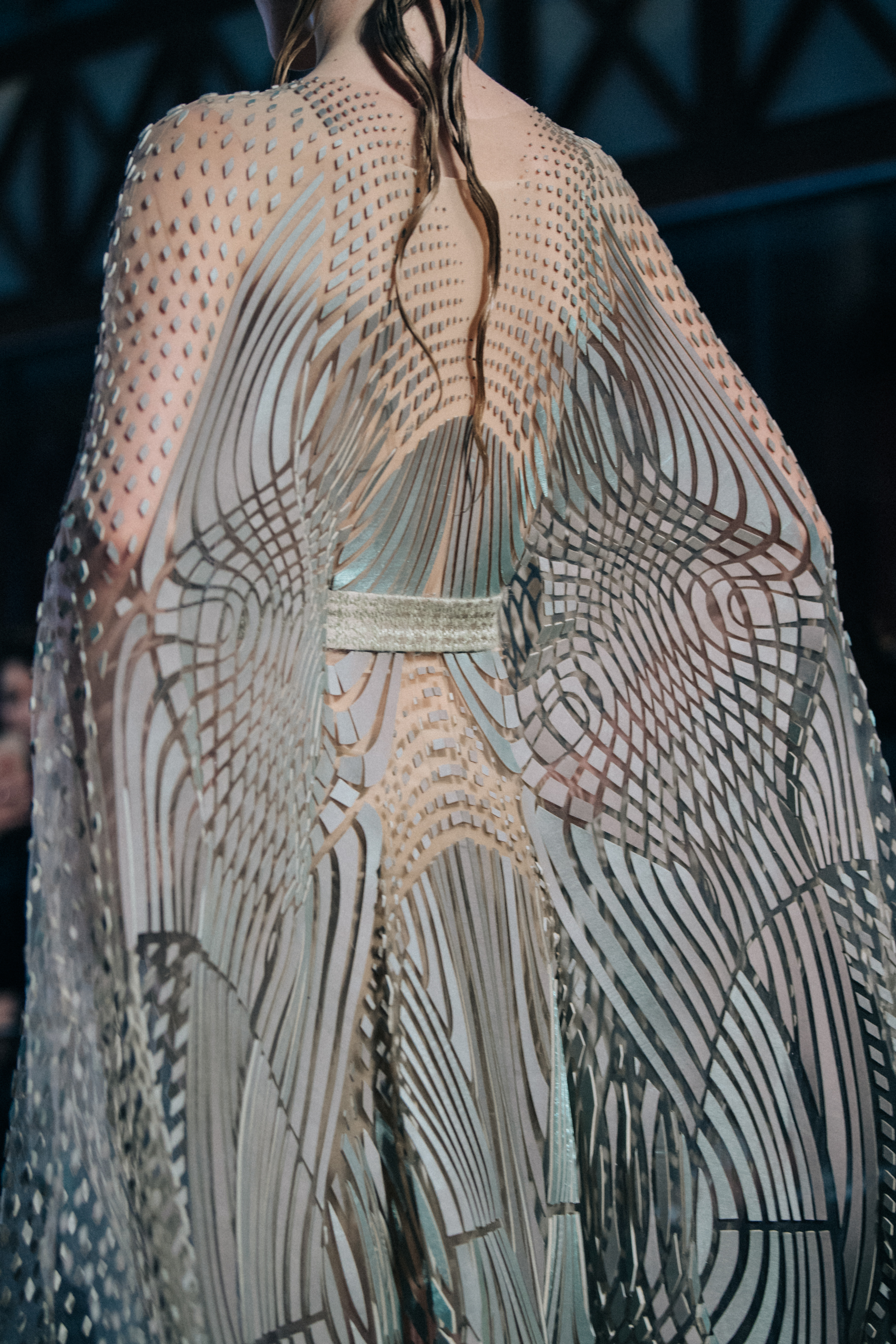Model wearing elegant dress on runway
