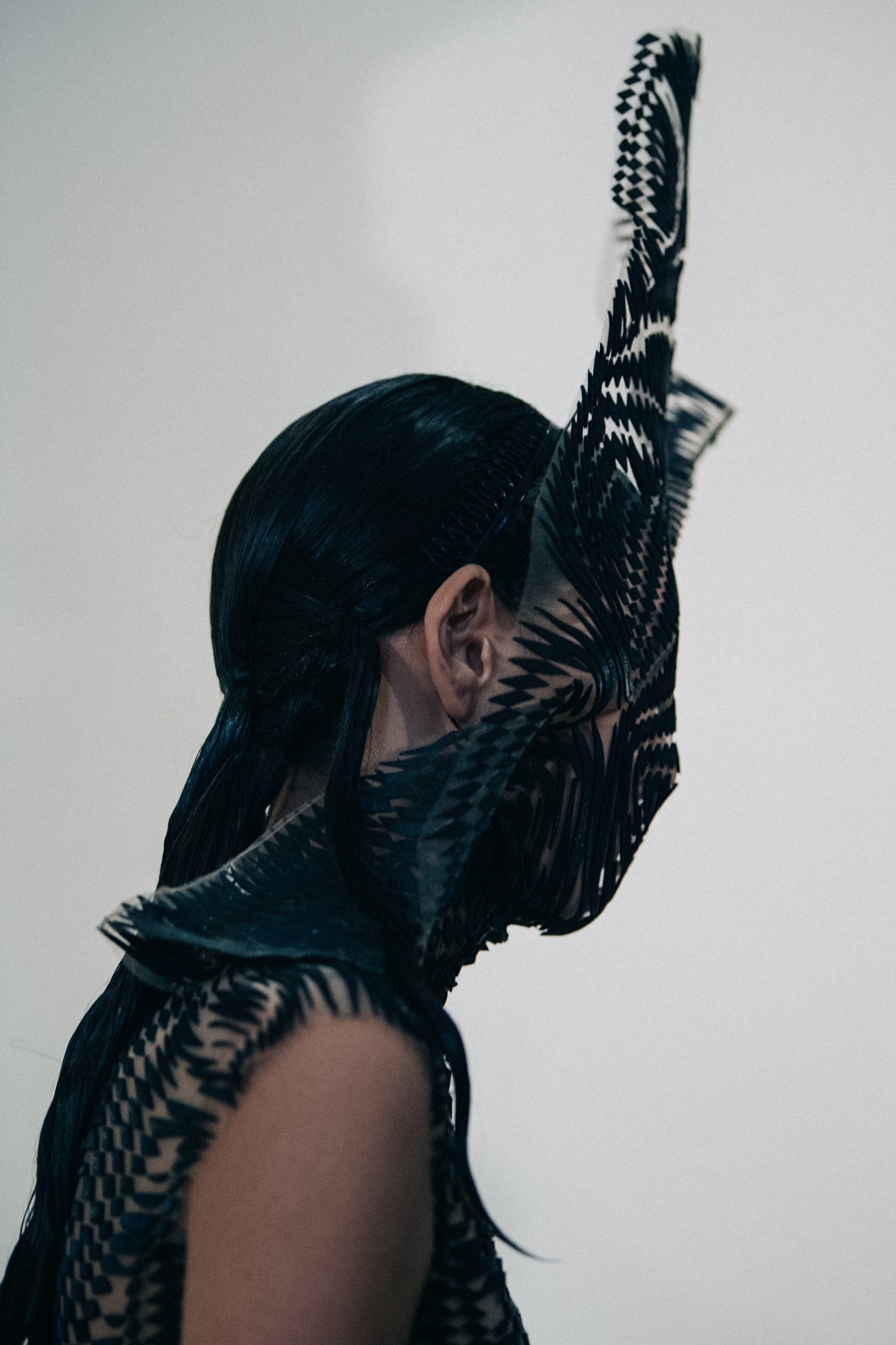 Model wearing black face mask and dress