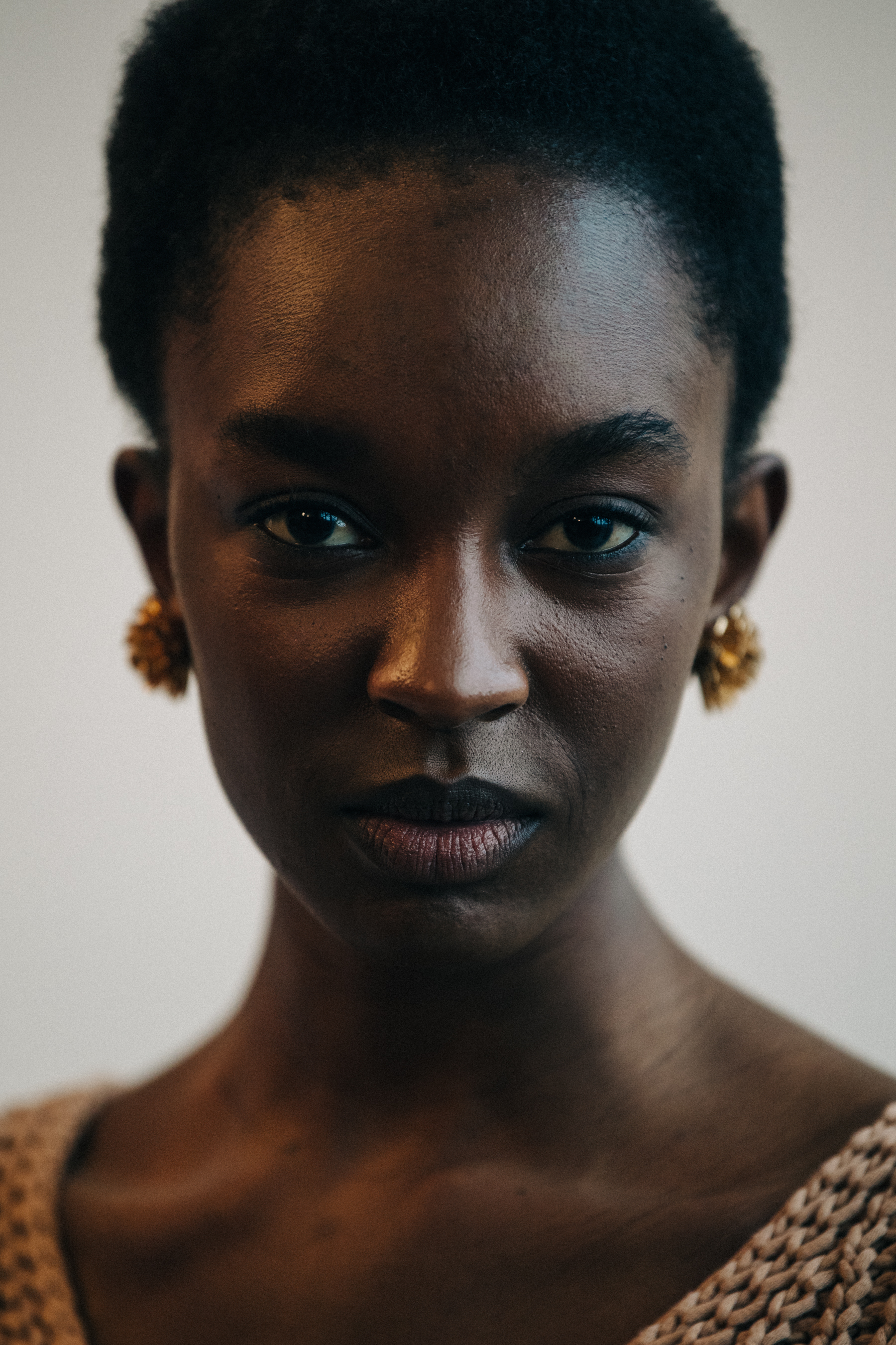 Portrait of model wearing gold earrings