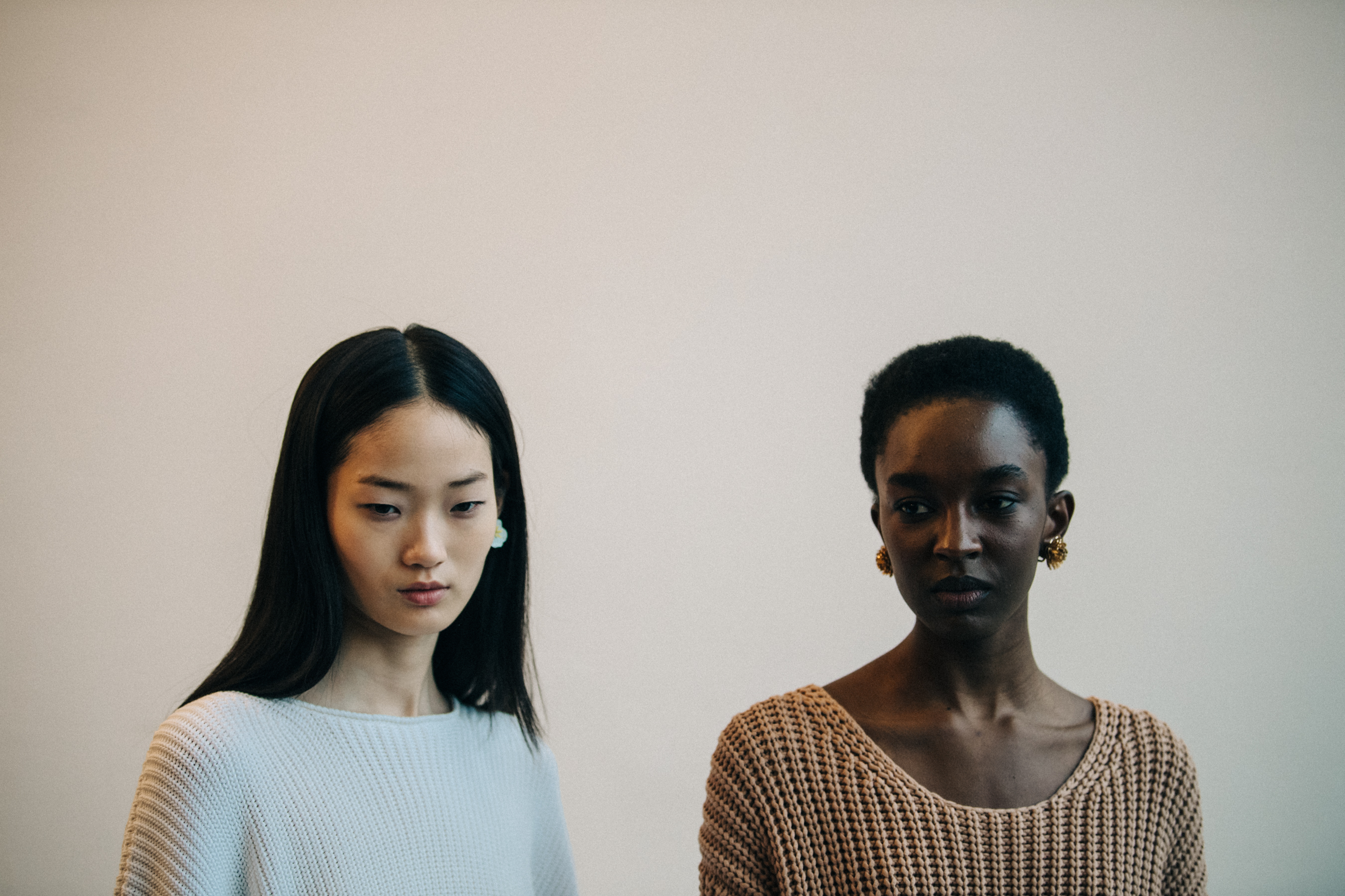 Two models wearing white and brown
