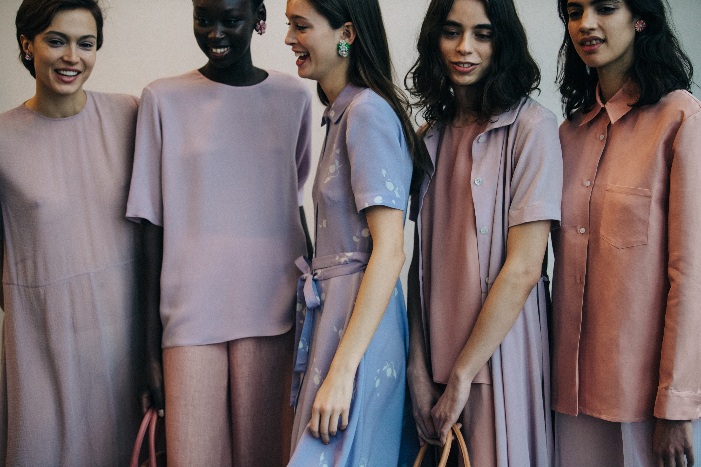 Models in lineup wearing pink and purple outfits