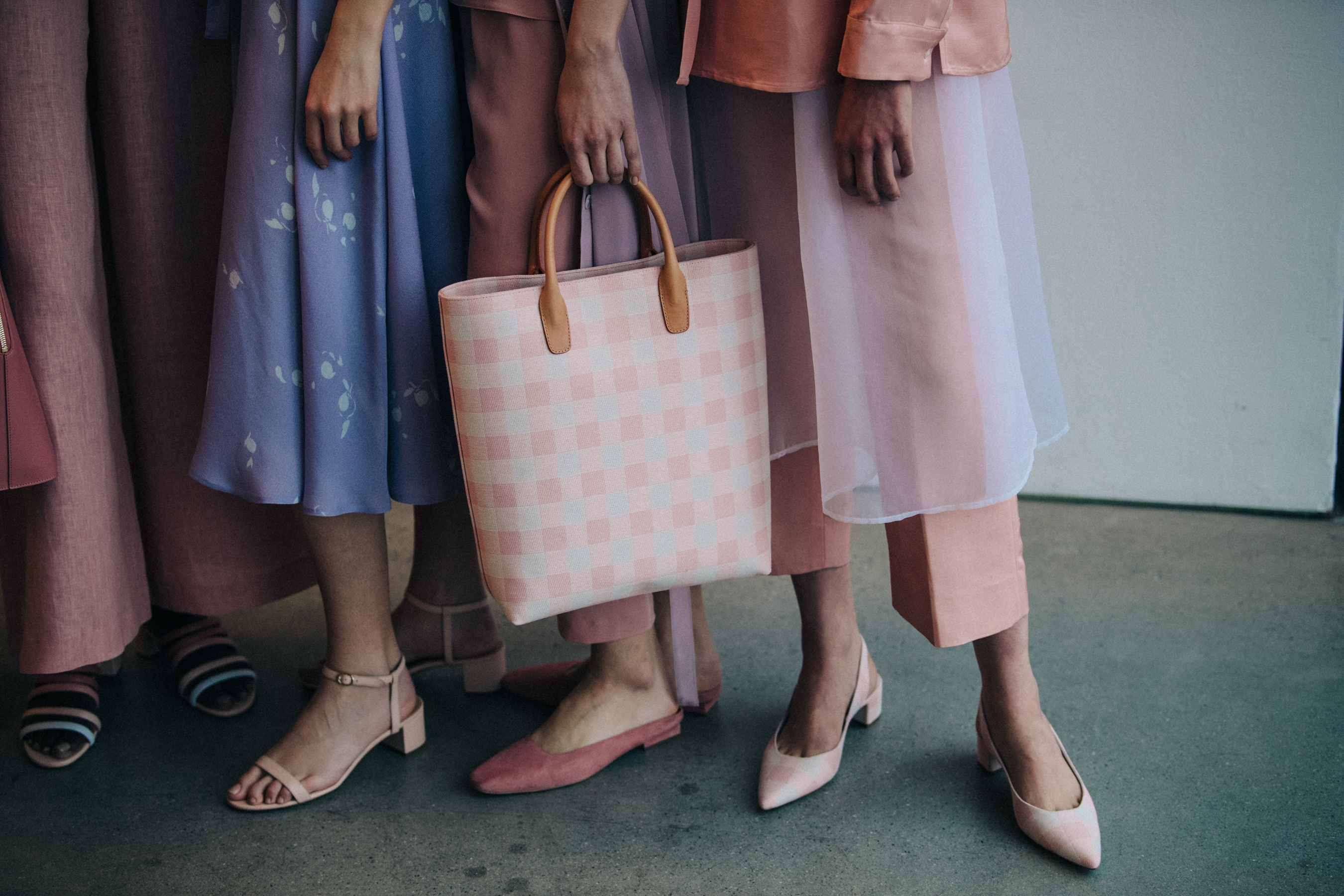 Models in lineup wearing pink and purple outfits