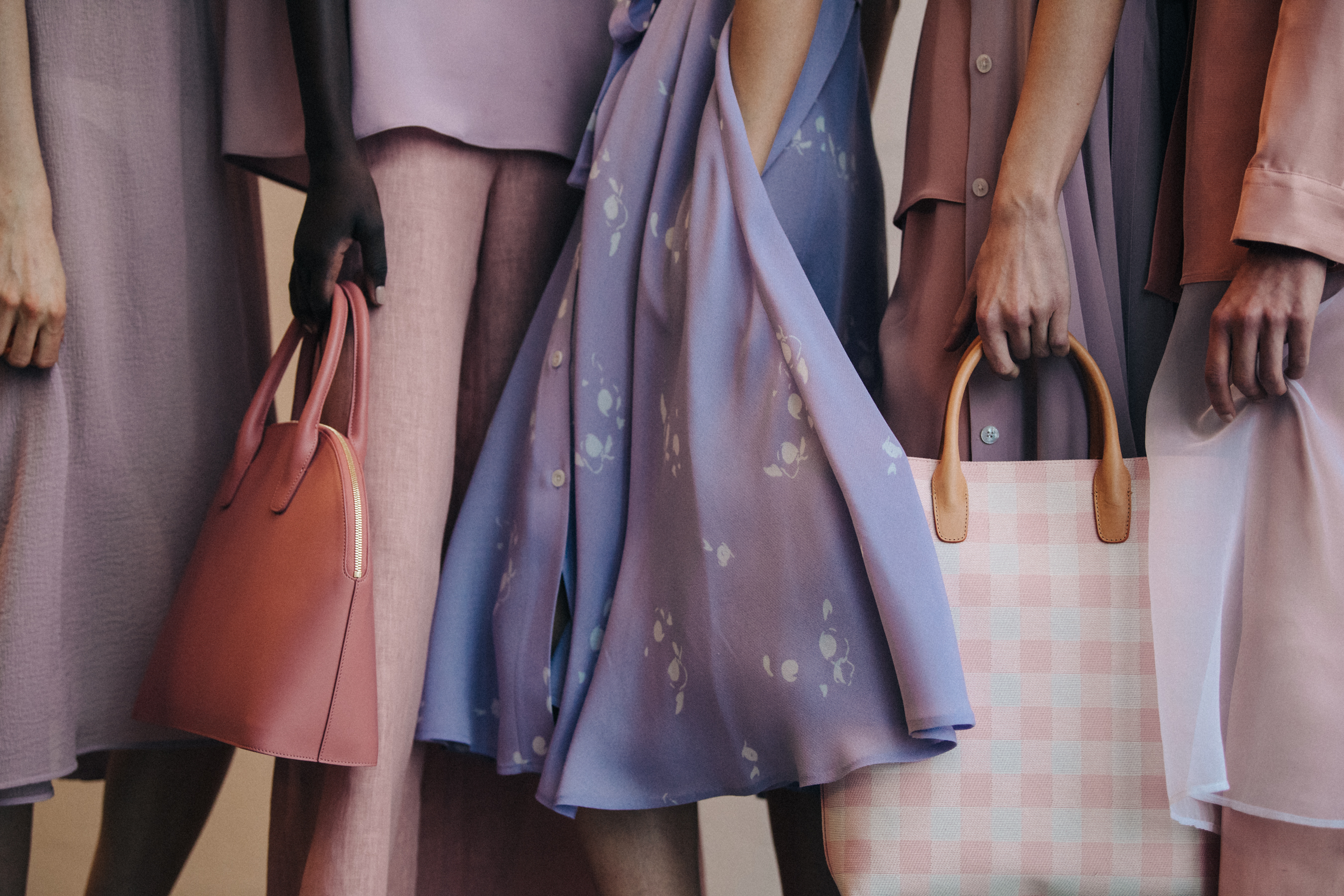 Models in lineup wearing pink and purple outfits