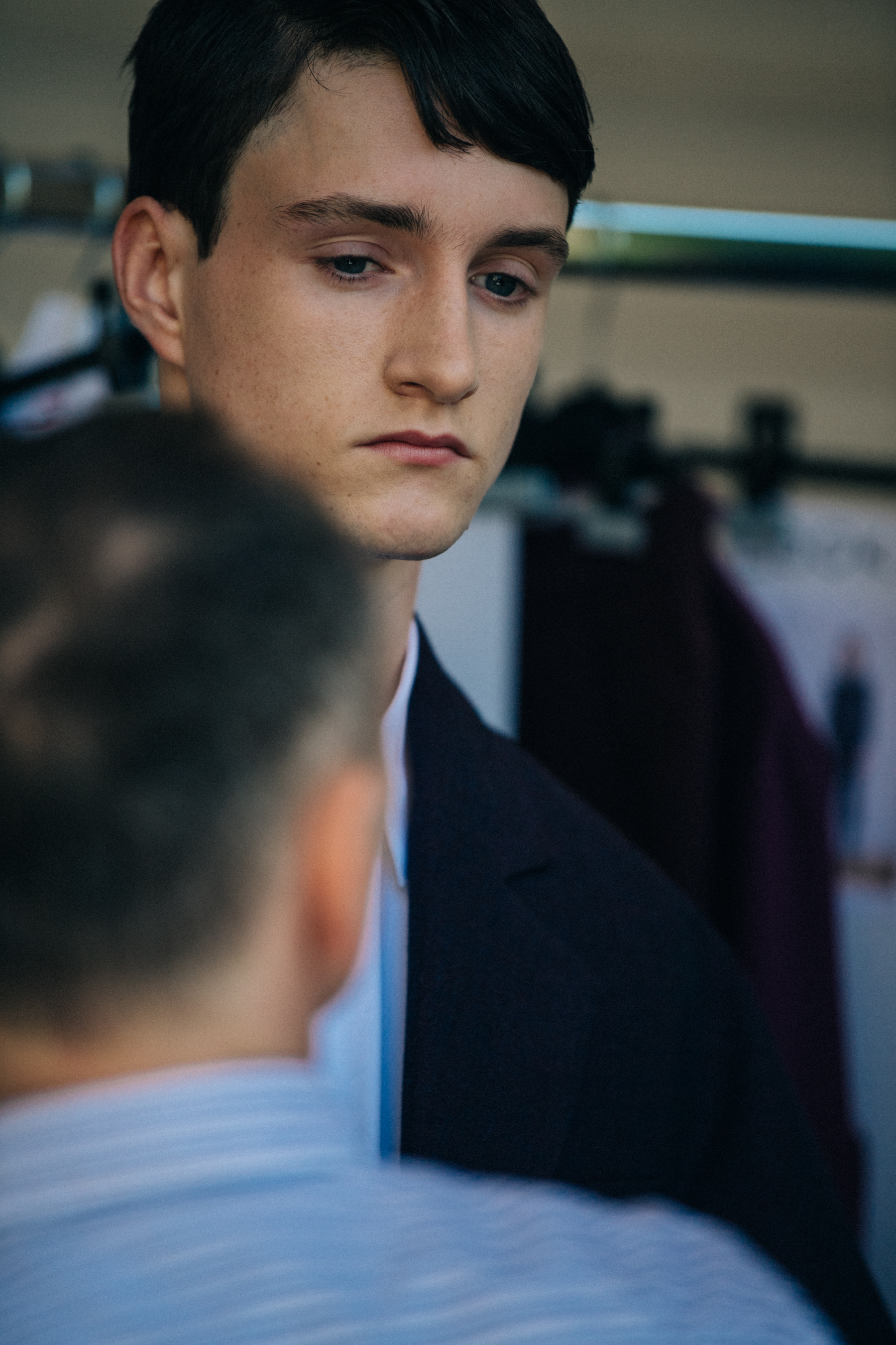 Model wearing white shirt backstage