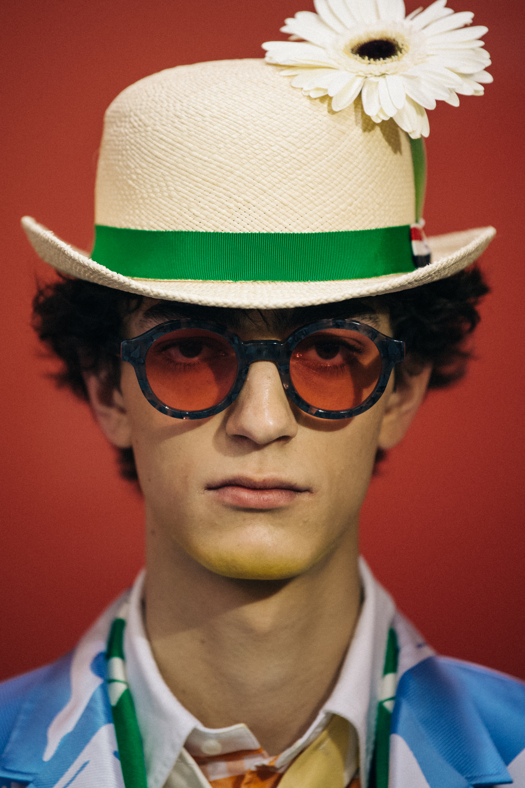 Portrait of model wearing hat with flower