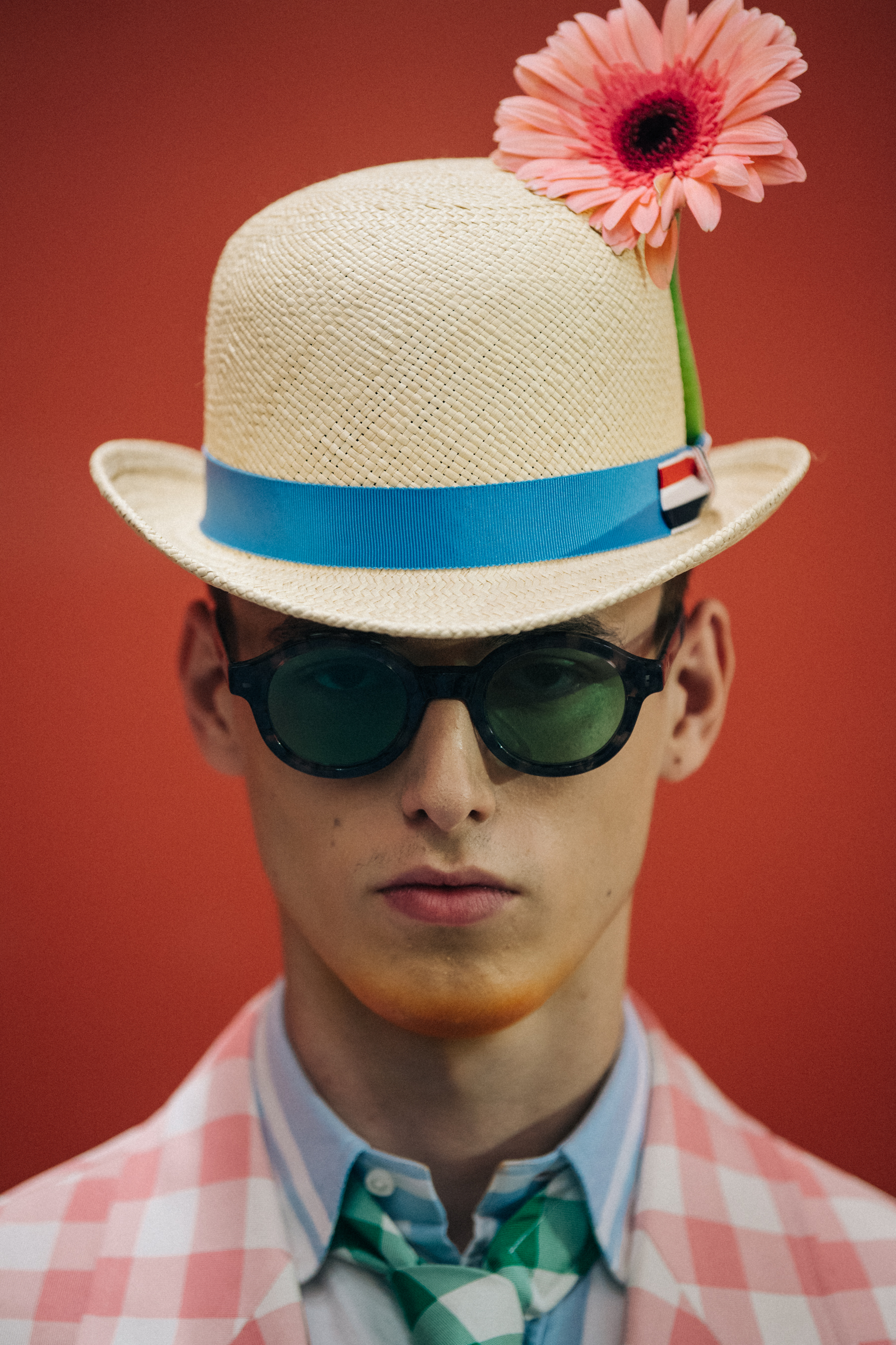 Portrait of model wearing hat with flower