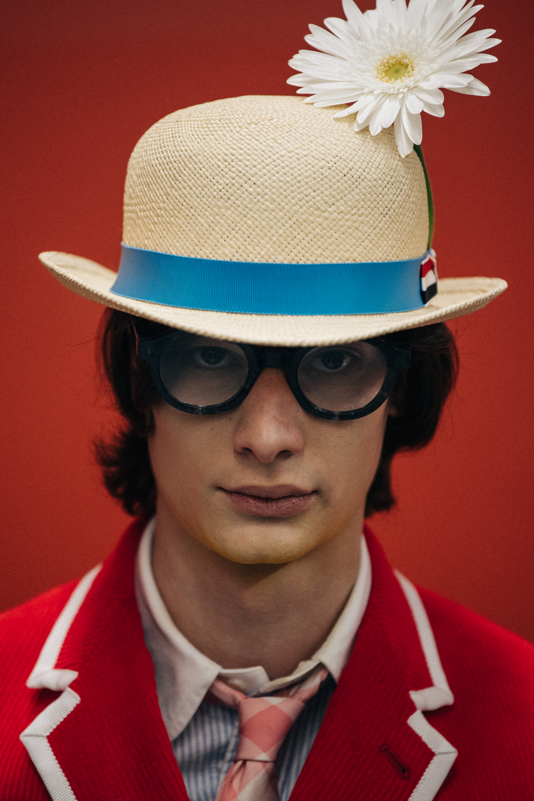 Portrait of model wearing hat with flower