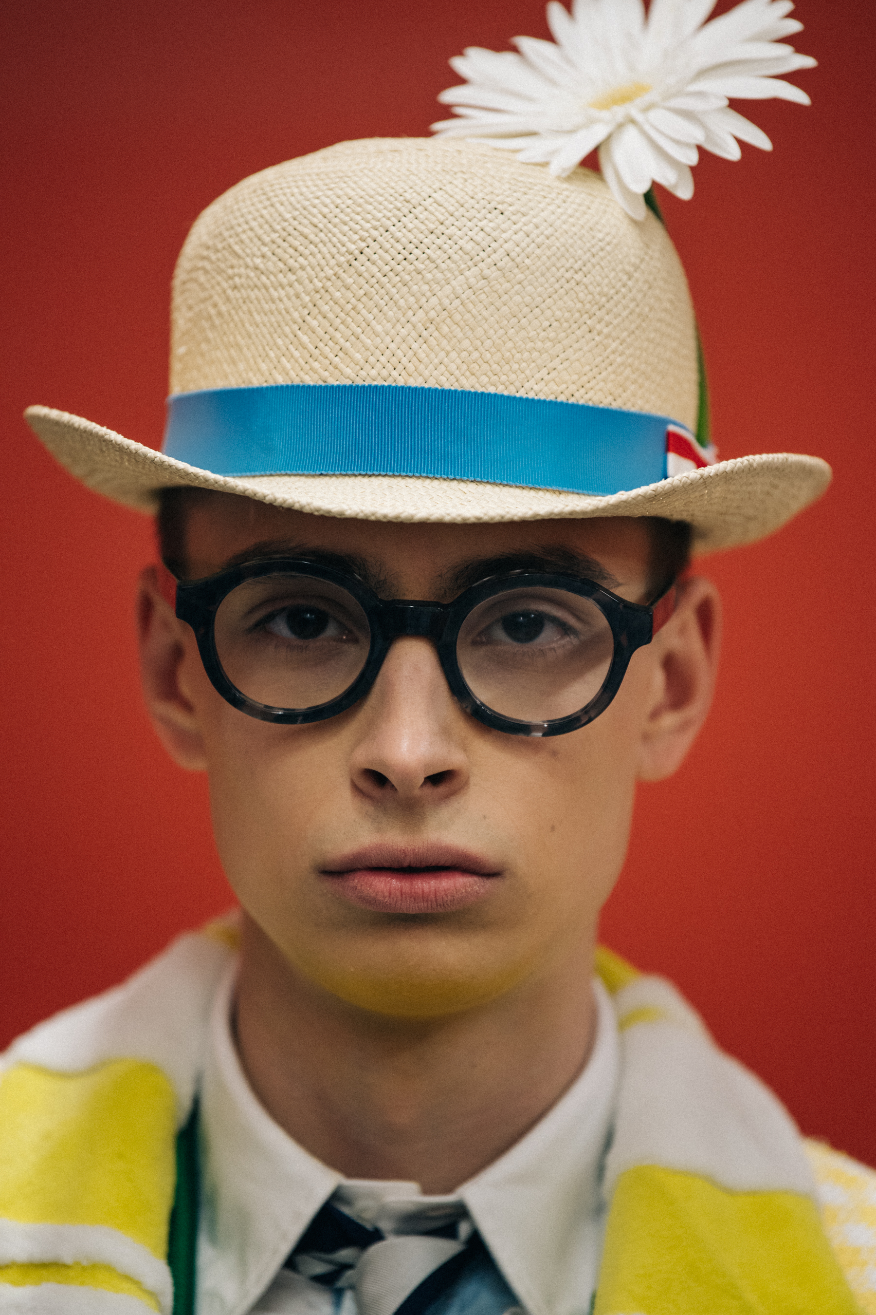 Portrait of model wearing hat with flower
