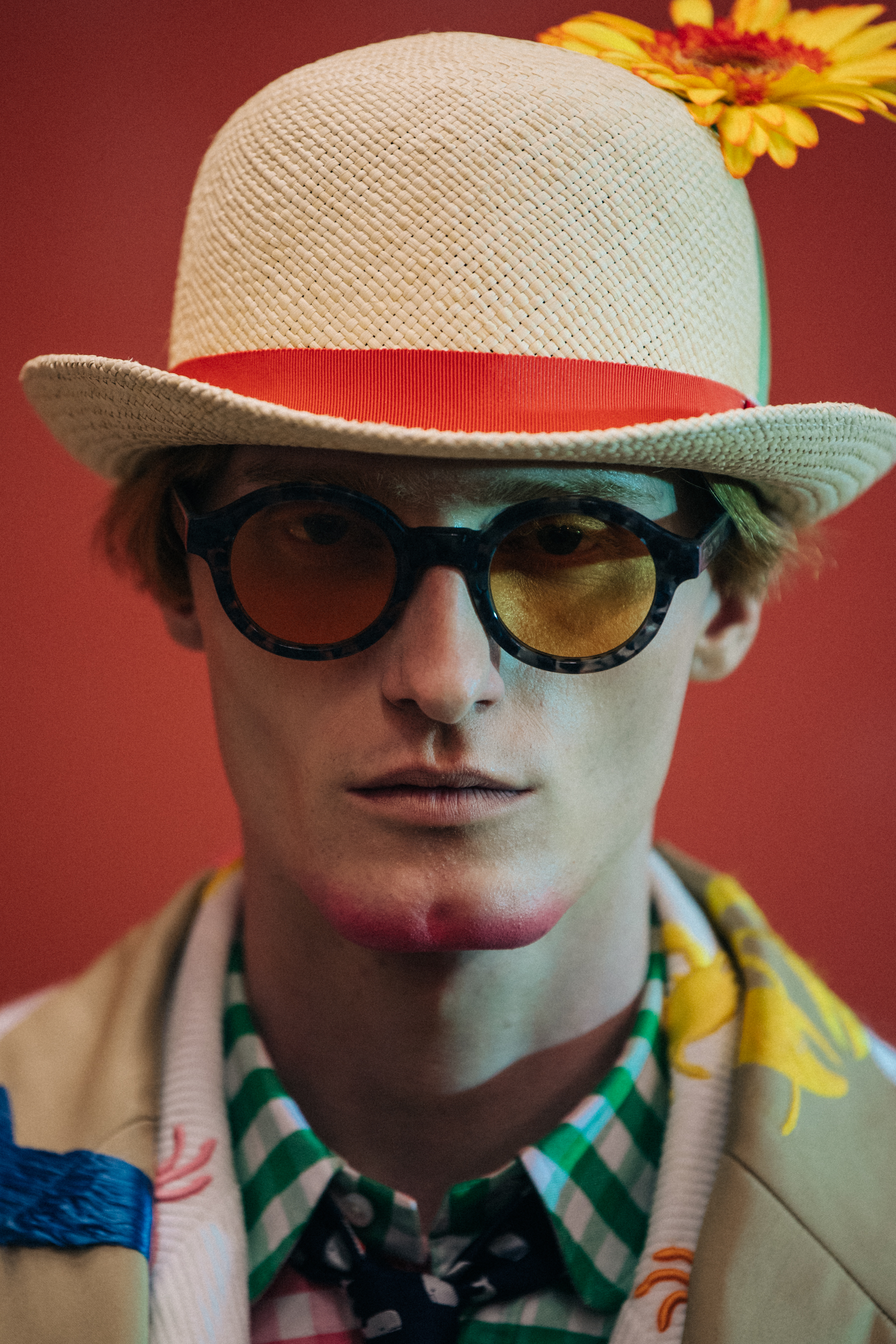 Portrait of model wearing hat with flower
