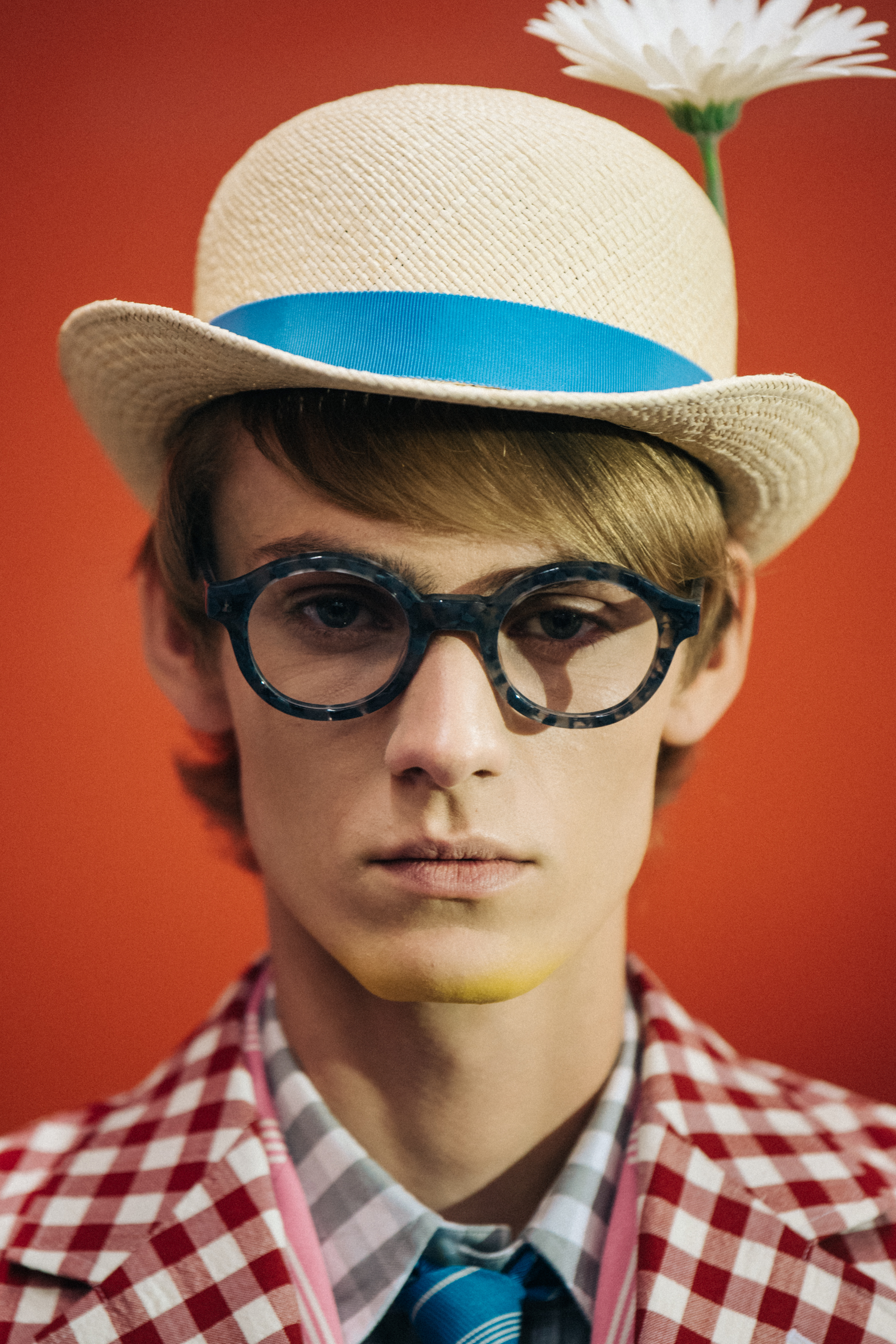 Portrait of model wearing hat with flower