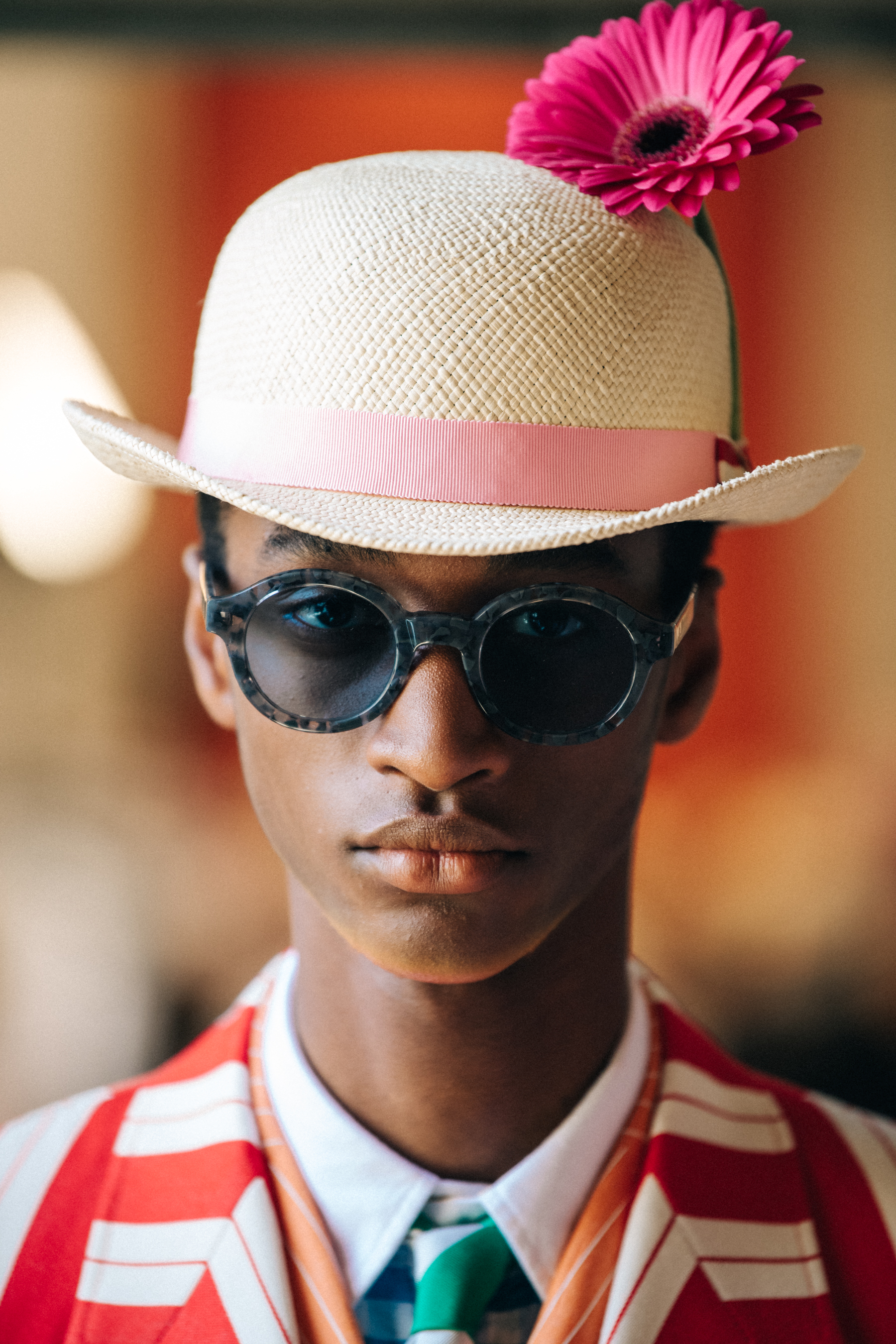 Portrait of model wearing hat with flower