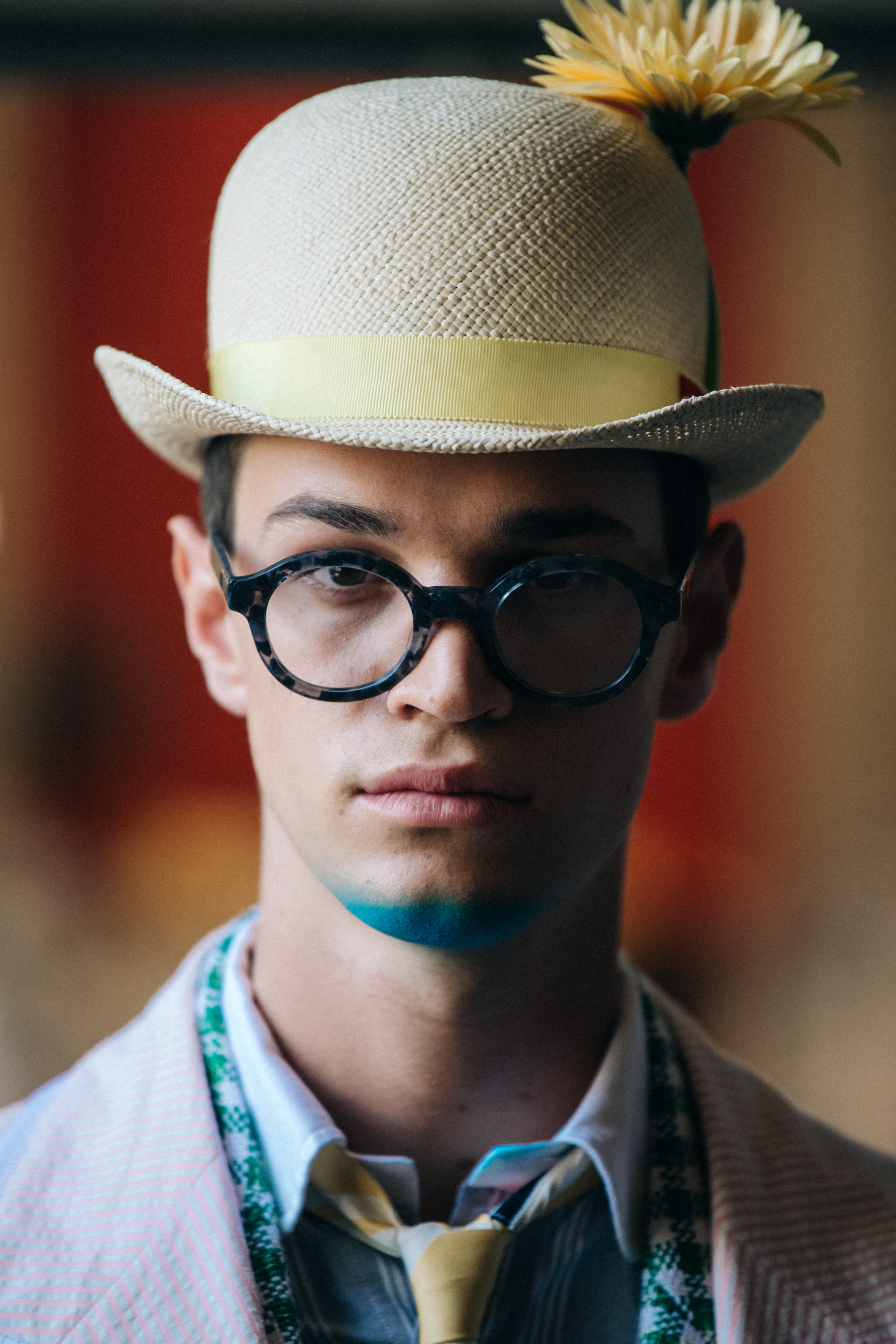 Portrait of model wearing hat with flower