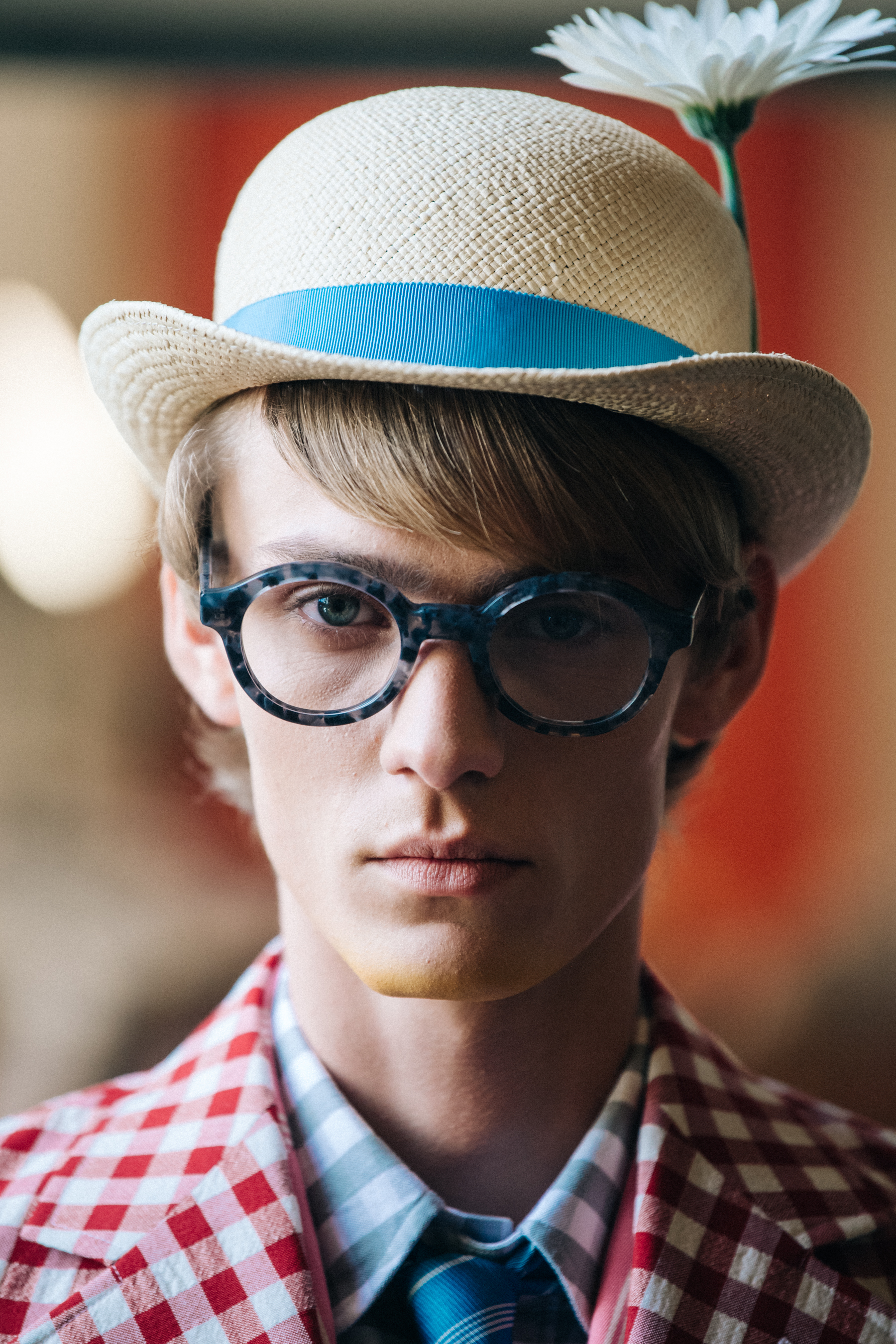 Portrait of model wearing hat with flower