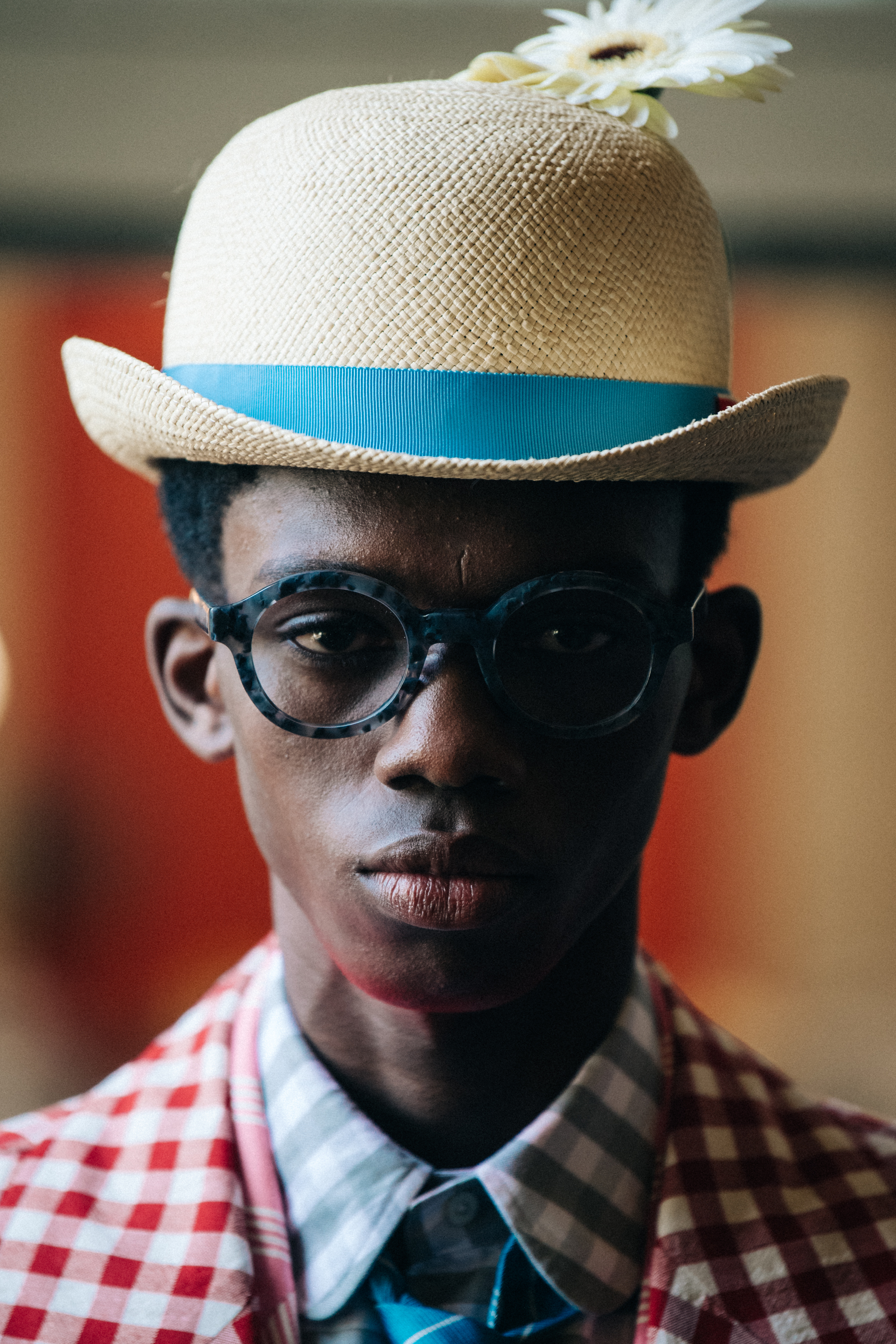 Portrait of model wearing hat with flower