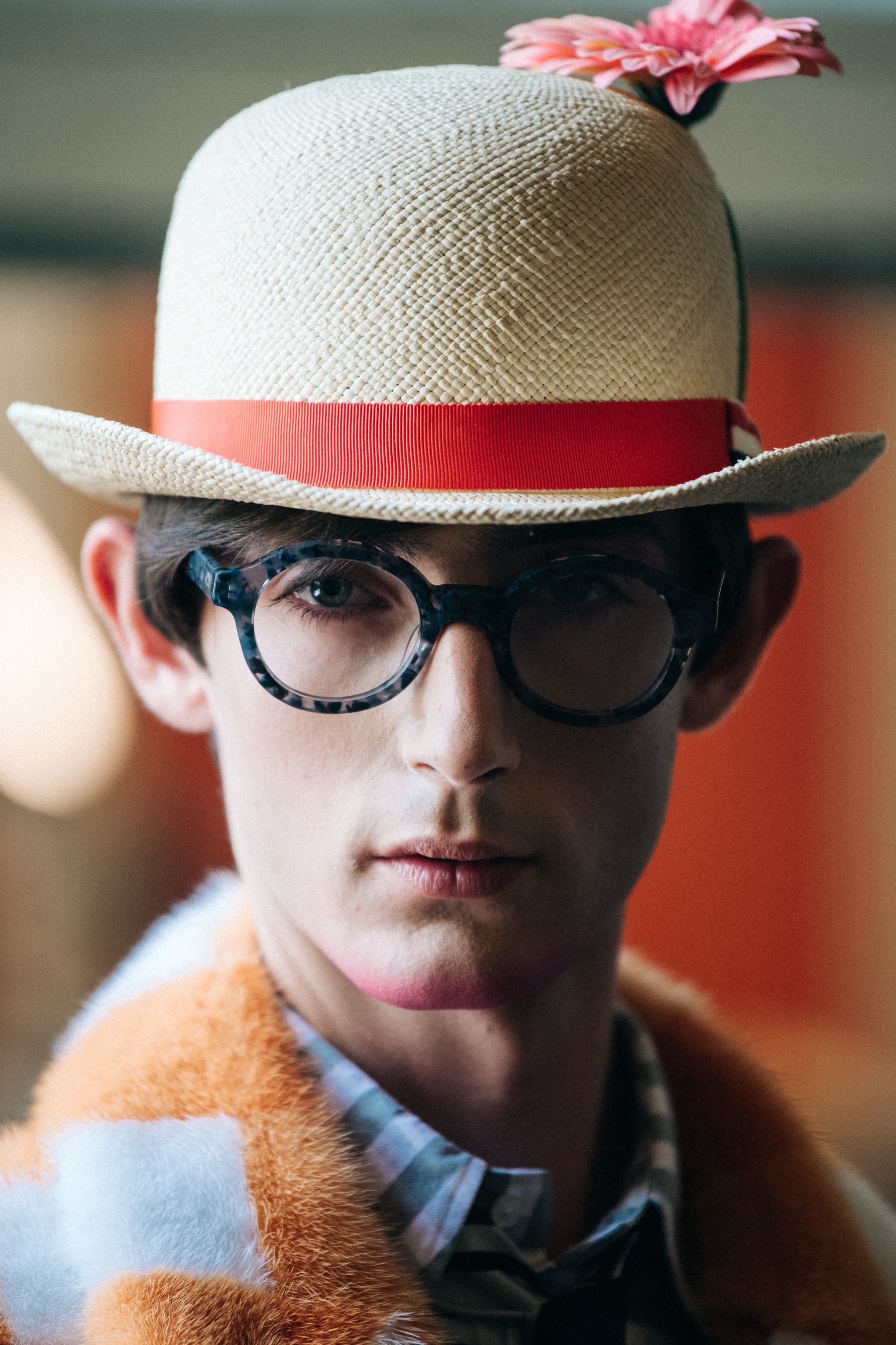 Portrait of model wearing hat with flower