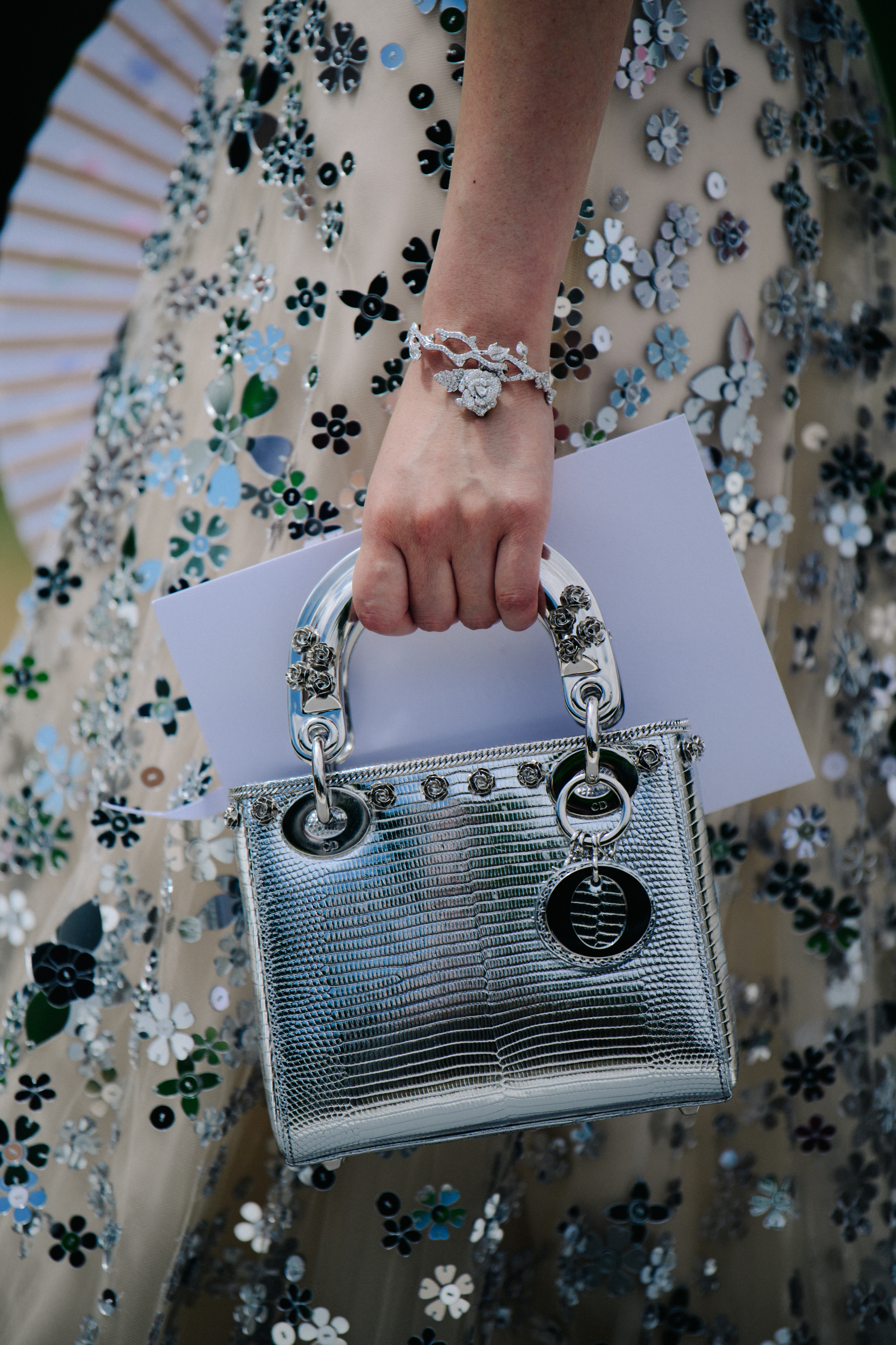 Woman carrying small silver bag