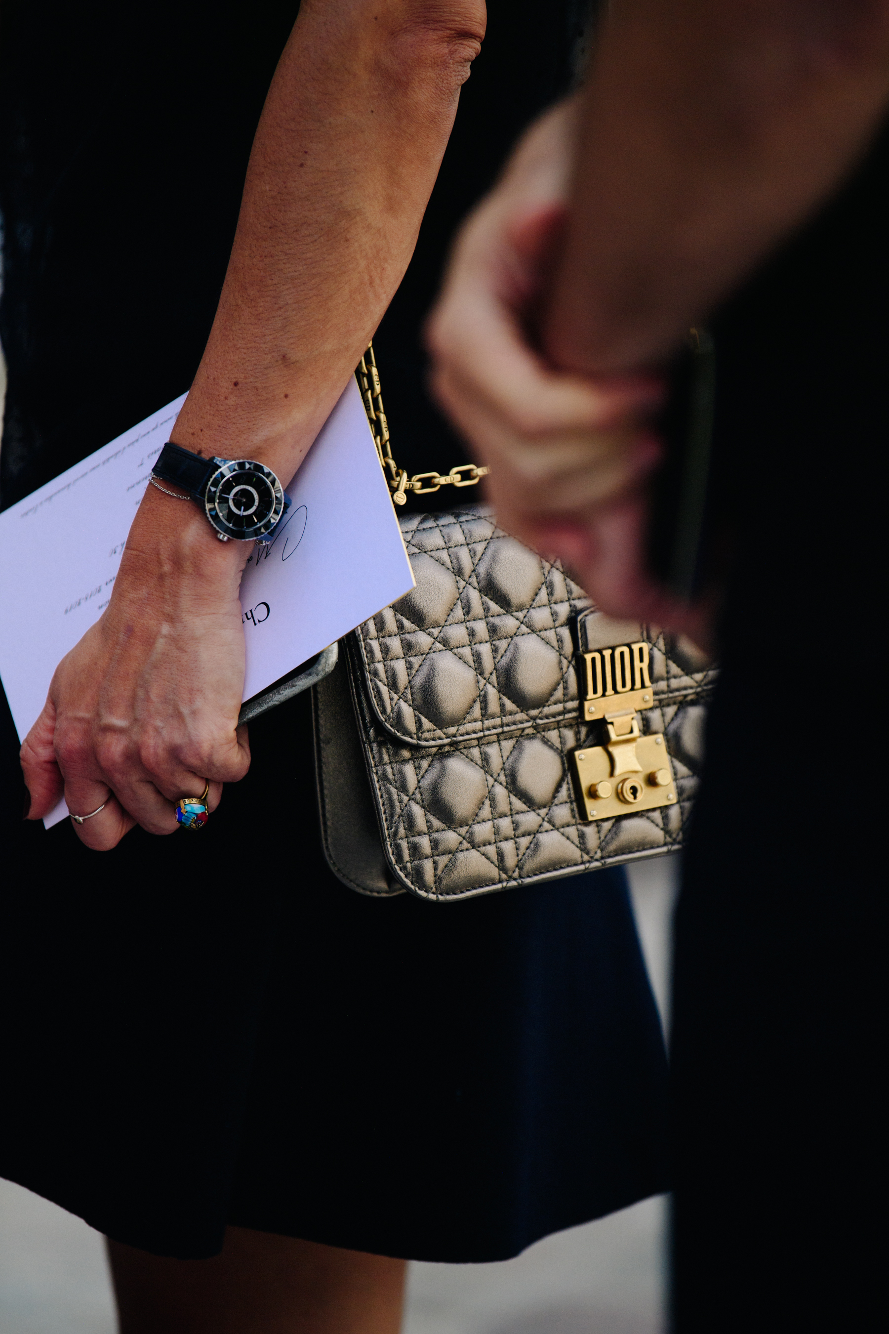 Woman wearing silver and black watch