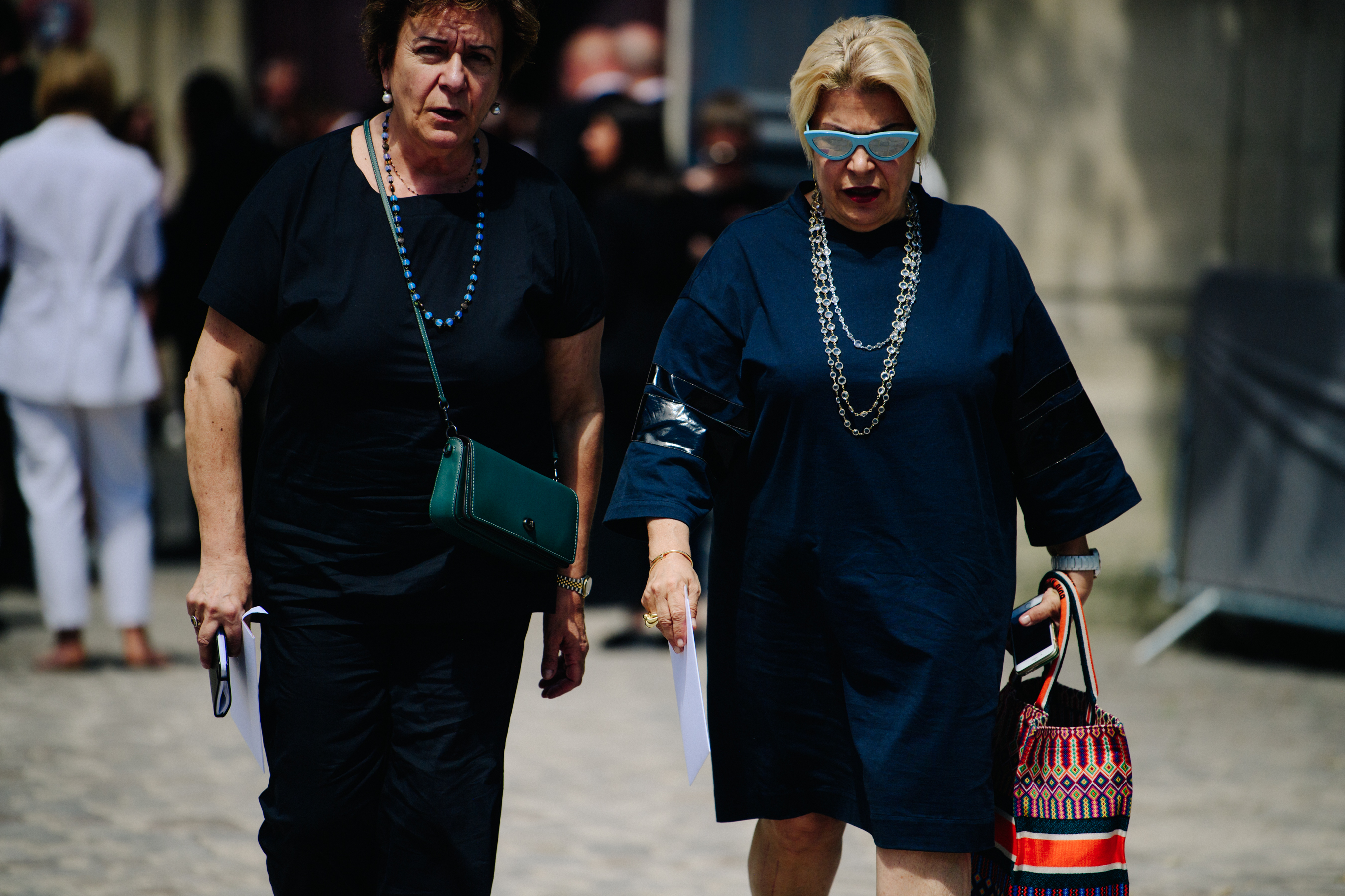 Two women wearing dark navy shirts