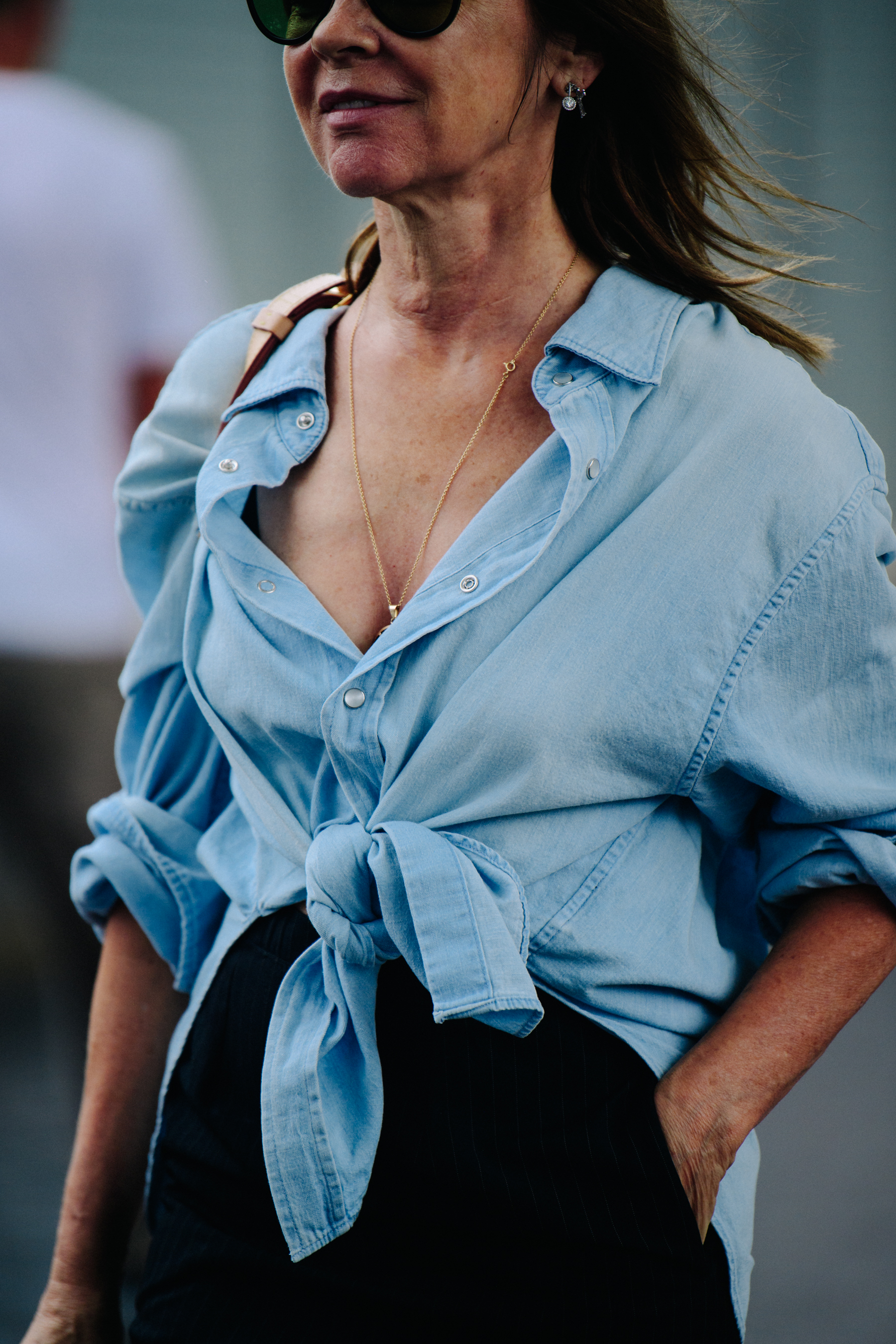 Editor wearing denim shirt