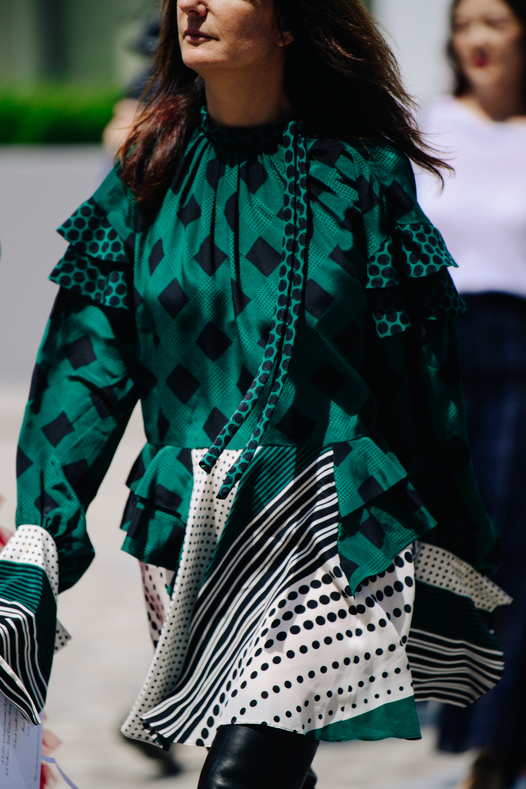 Woman wearing green diamond pattern top
