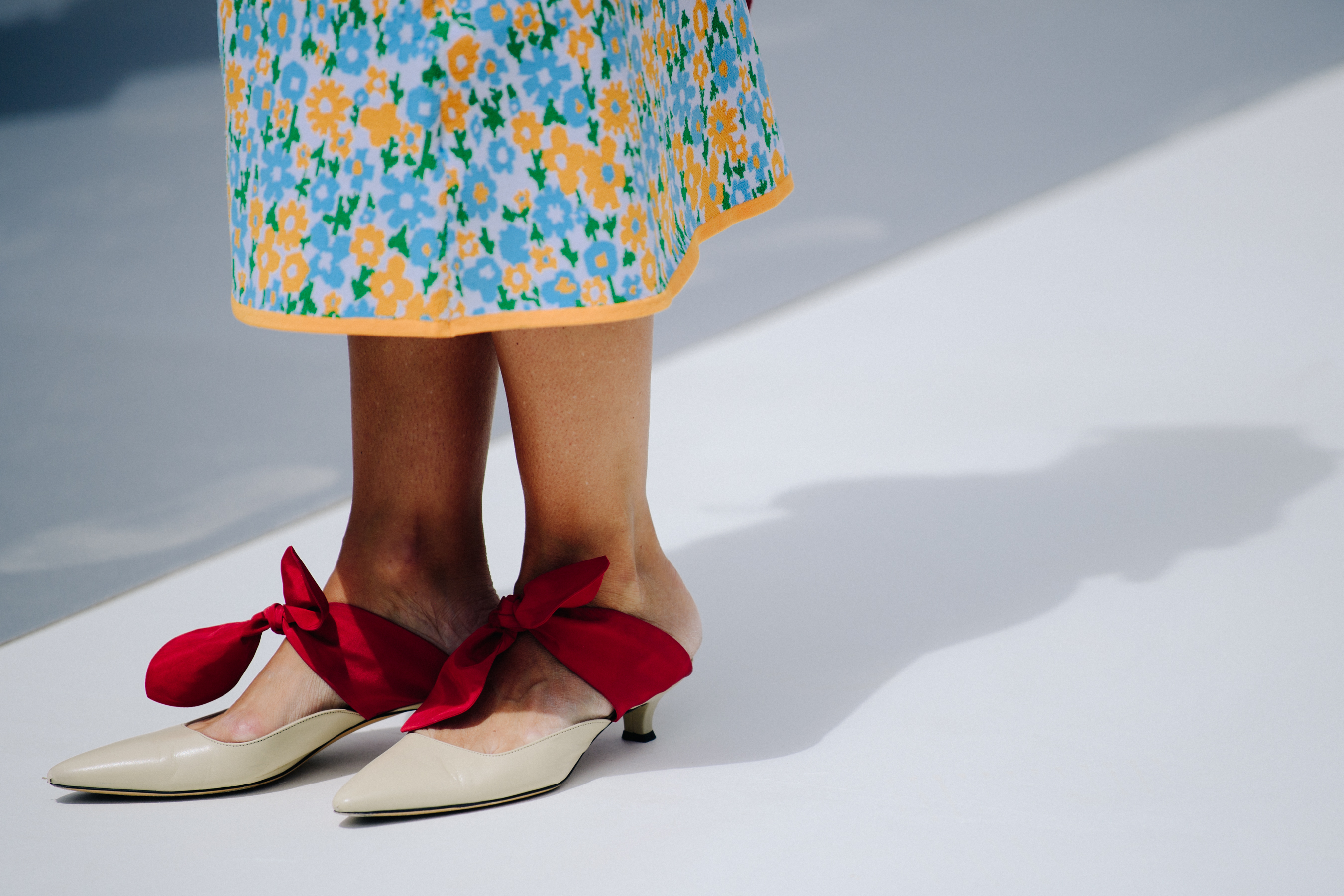 Woman wearing red bow shoes