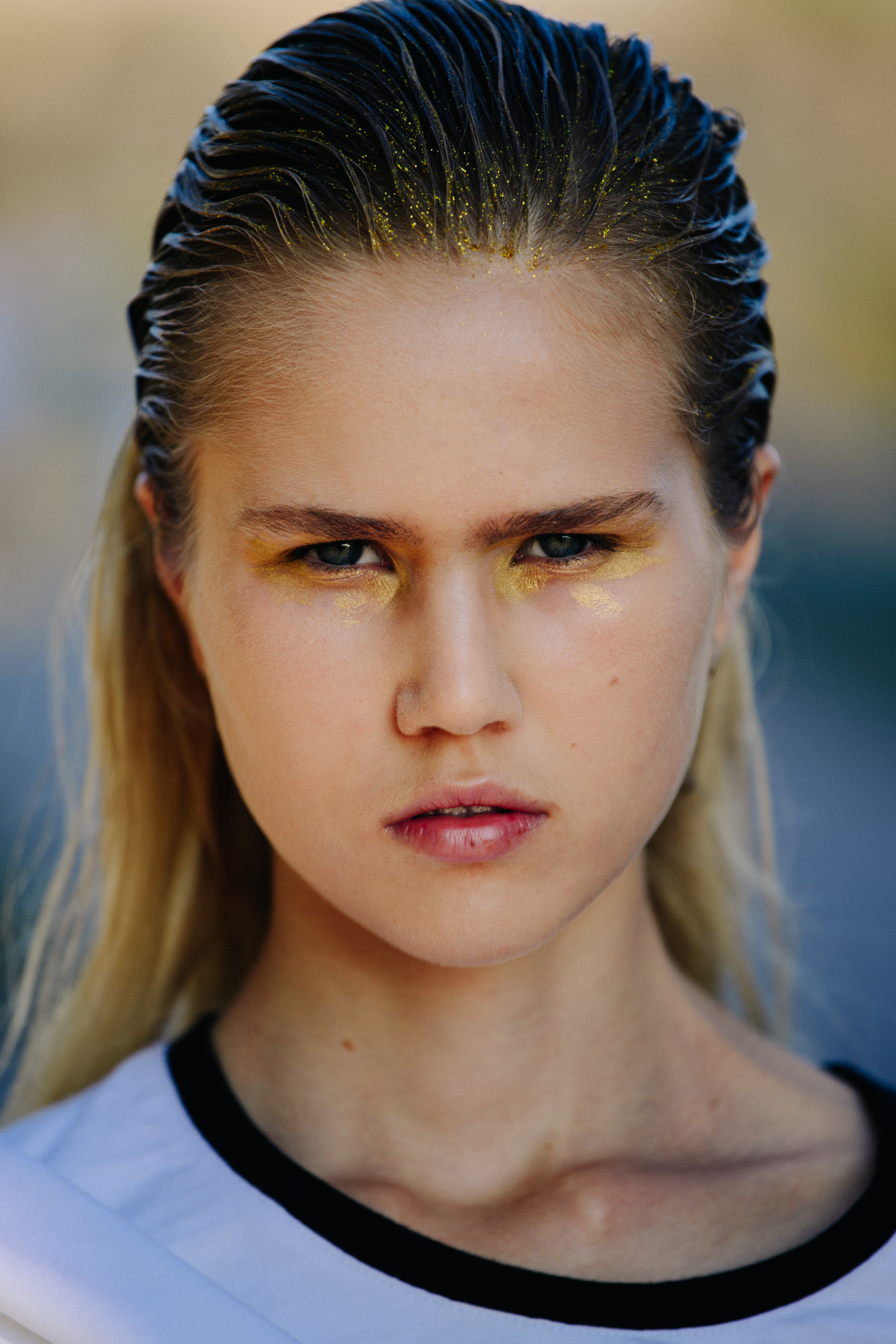 Portrait of model wearing gold eye makeup